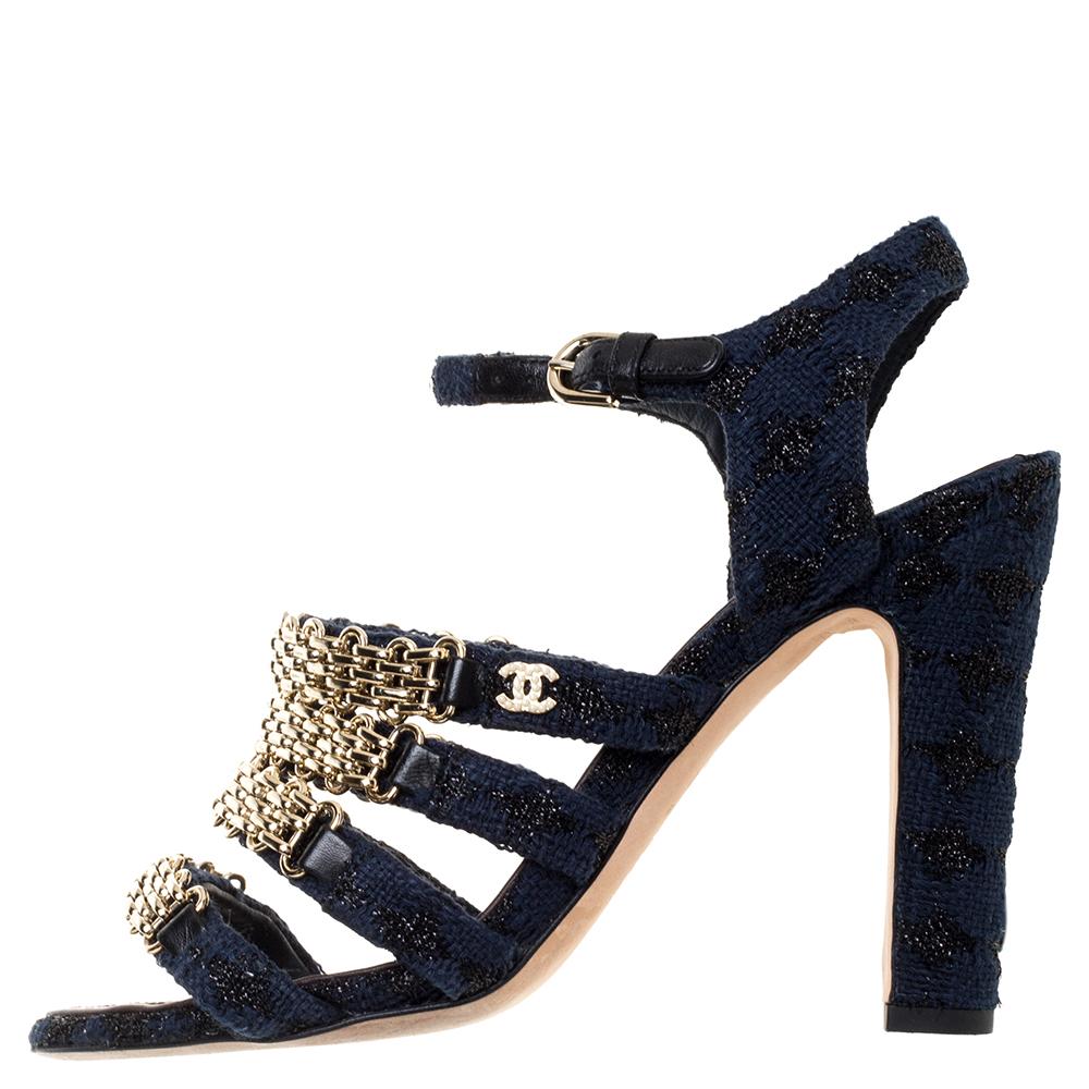 Flaunt this must-have Chanel creation as you step out in style. This classic fabric pair features chain detailing on the front straps with 11 cm heels and a buckle ankle strap closure. These striking blue-hued sandals are further detailed with a CC