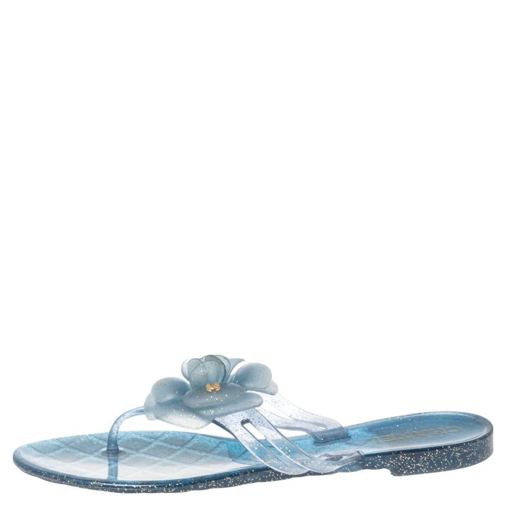 Comfort coupled with fashion creates wonders and these sandals from Chanel are an example of that. These blue flat sandals are crafted from glitter jelly into a thong design. They flaunt the signature Camellia flower with the CC logo on the uppers.