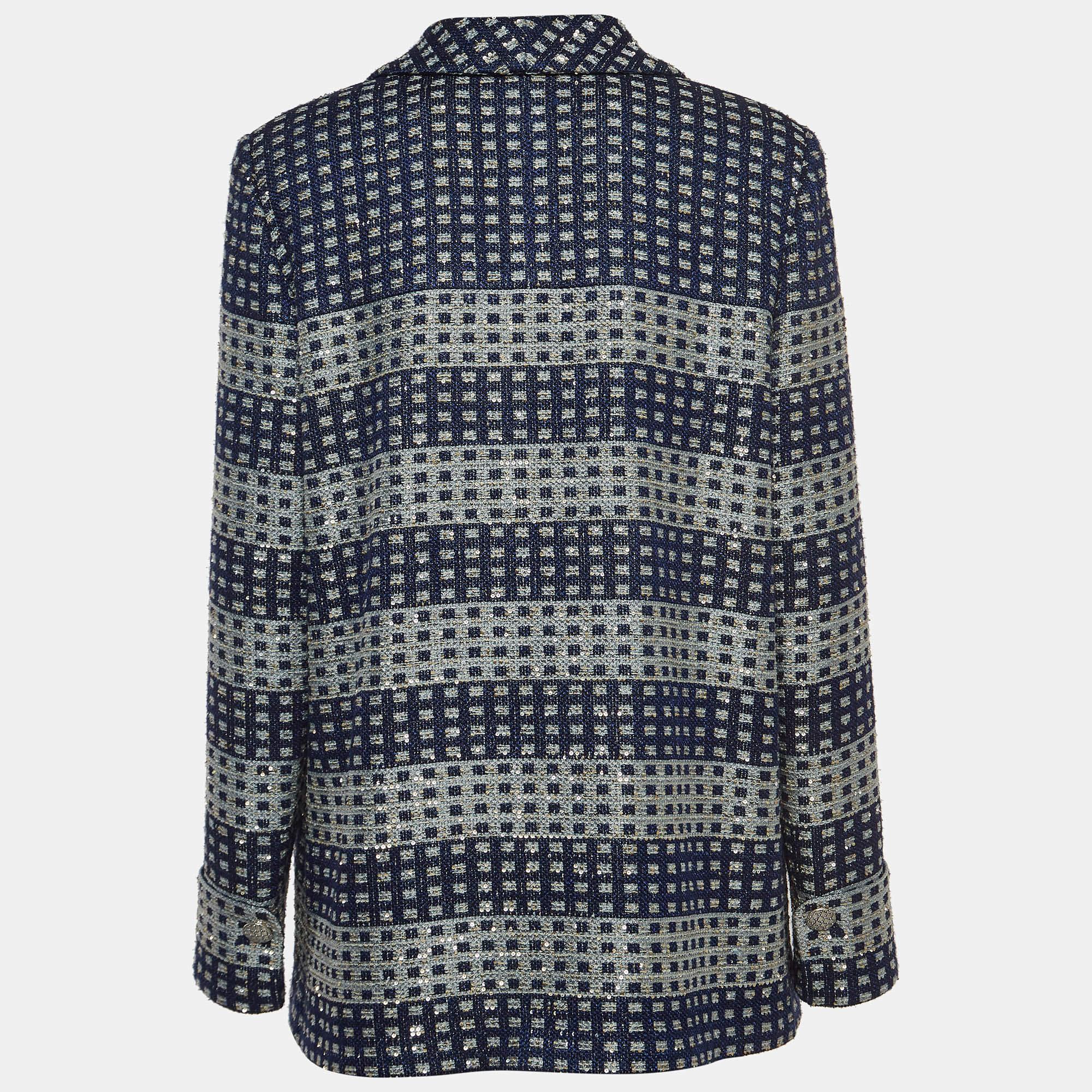 The Chanel jacket is a luxurious fashion statement. Crafted from high-quality glitter tweed, it features intricate blue sequin embellishments that create a captivating contrast against the blue base. With its iconic Chanel design, this jacket exudes