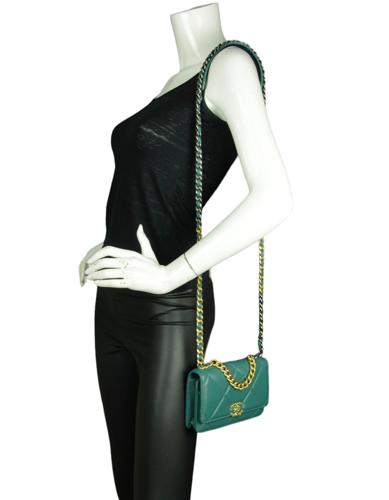 Chanel Blue-Green Quilted 19 Wallet On Chain WOC Crossbody Bag

Made In: Italy
Color: Blue-green
Hardware: Goldtone, darkened silver, ruthenium
Materials: Lambskin leather
Lining: Leather & grosgrain
Closure/Opening: Flap top with magnetic snap