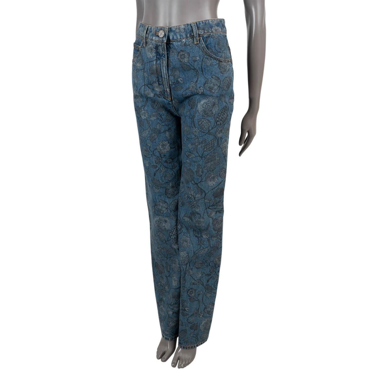 100% authentic Chanel straight-leg jeans in blue denim (please note the content tag is missing) with gray hand painted floral pattern. Features a high rise and classic five pocket design. Closes with a metal CC button and are unlined. Have been worn