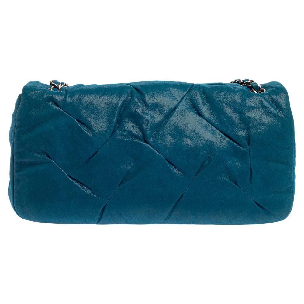Known for its timeless and luxurious pieces, the house of Chanel offers the best of luxury. This Chanel East West flap bag is just right for every occasion. This shoulder bag is crafted from leather that flaunts a blue iridescent glint. It is held