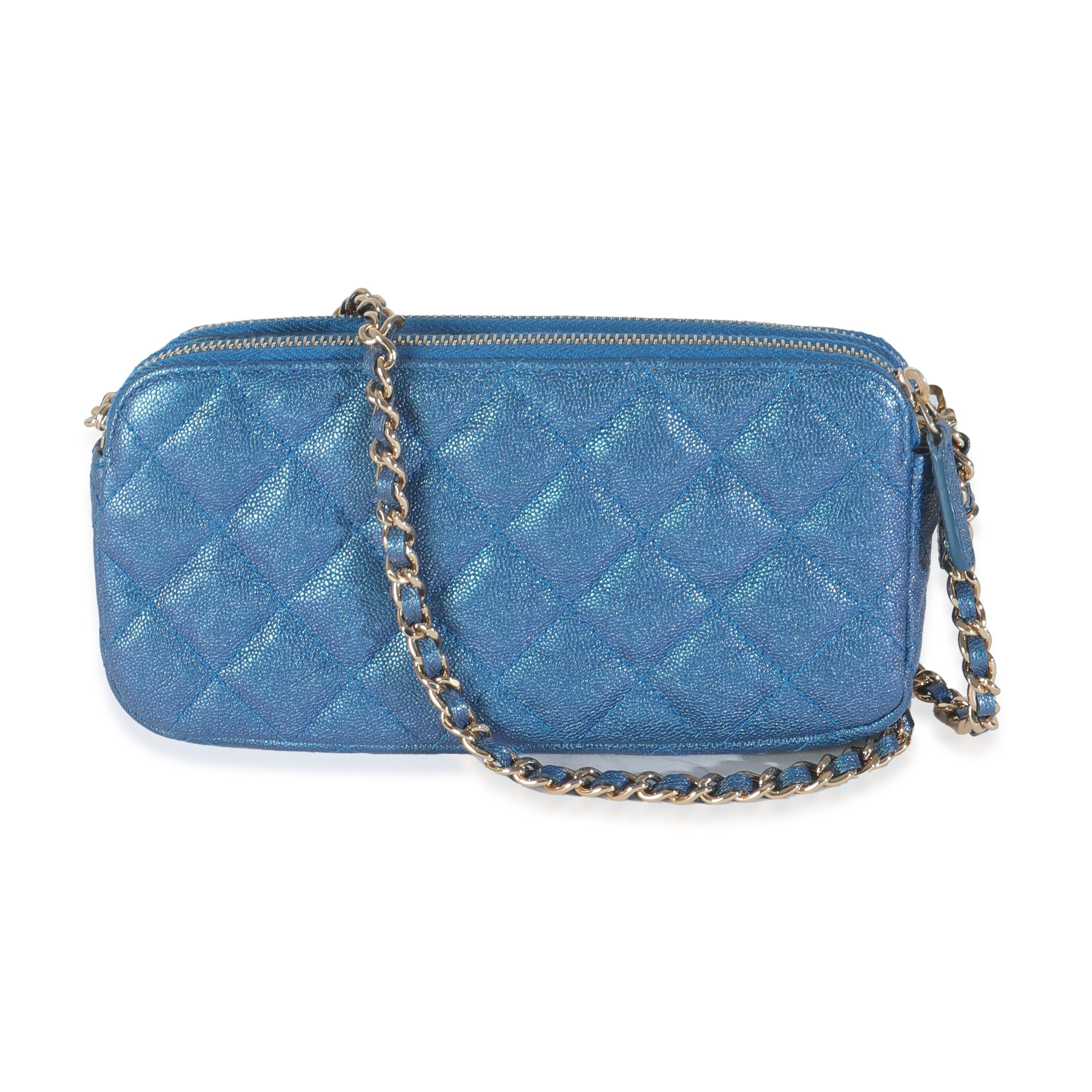 Listing Title: Chanel Blue Iridescent Quilted Caviar Small Clutch With Chain
SKU: 144625
Condition: Pre-owned 
Handbag Condition: Excellent
Condition Comments: Item is in excellent condition and displays light signs of wear. Faint wear along