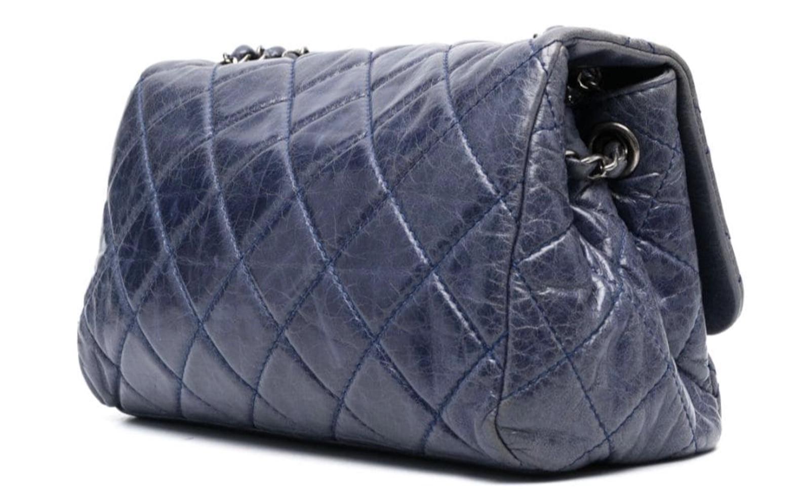Chanel by Karl Lagerfeld blue jean lambskin quilted Timeless bag featuring a quilted pattern, blue jean tumbled quilted leather, silver-plated hardware with iconic 'CC' front closure, metal and leather interwoven shoulder and crossbody strap, red