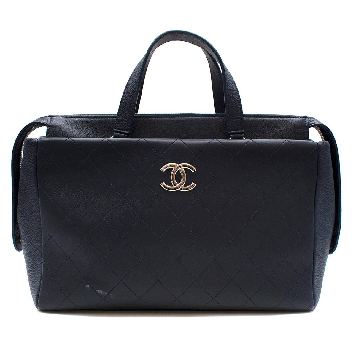 Chanel Blue Lambskin & Caviar Calfskin CC Top Handle Shopper

- Legendary CC logo 
- Silver-tone hardware 
- Top handles 
- Zip fastening to the top 
- It comes with a leather shoulder strap that sits easily on the shoulders
- Pockets to the front