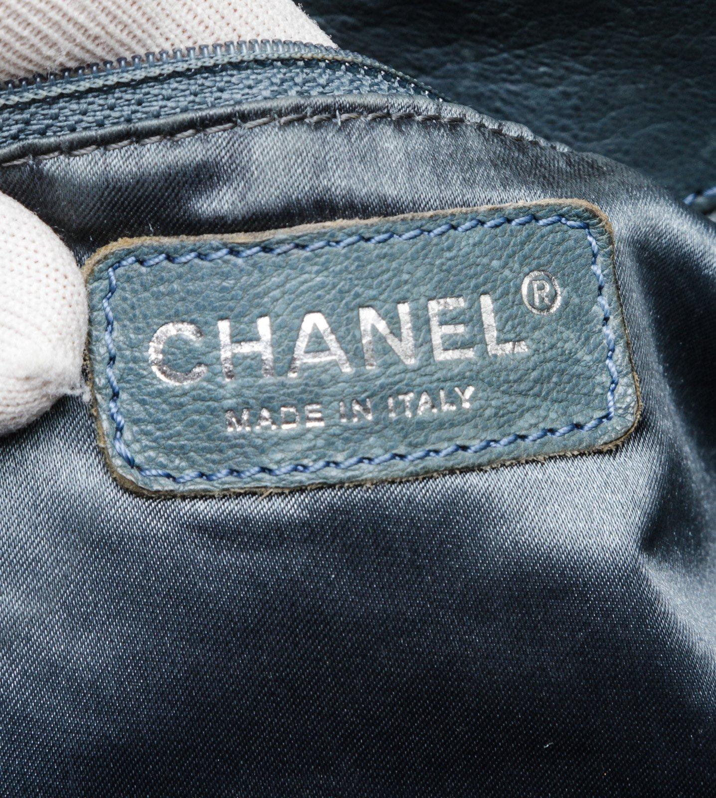 Chanel blue leather Coco Cabas shoulder bag with silver-tone hardware, chain-link and leather straps, CC charm at front, quilting detail at base, tonal satin lining, interior zip pocket, two interior slip pockets, and magnetic snap closure. Optional