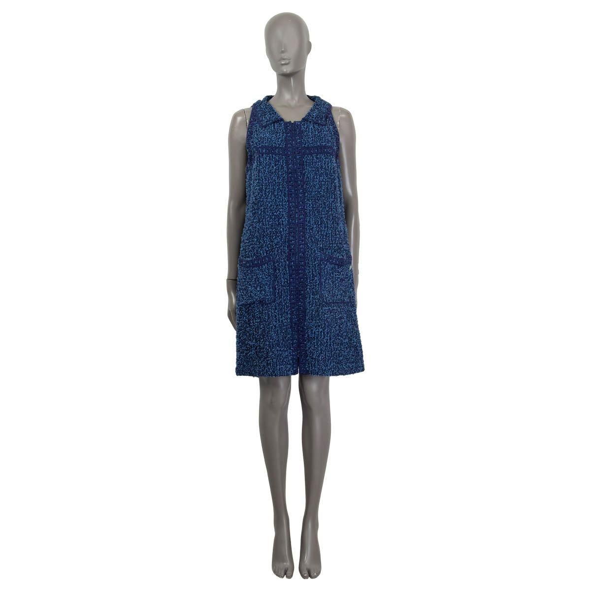 100% authentic Chanel sleeveless tweed dress in blue and navy cotton (57%), nylon (36%) and wool (7%). Features two patch pockets on the front and an embroidered trim. Opens with a concealed zipper and a hook at the front. Lined in blue cotton