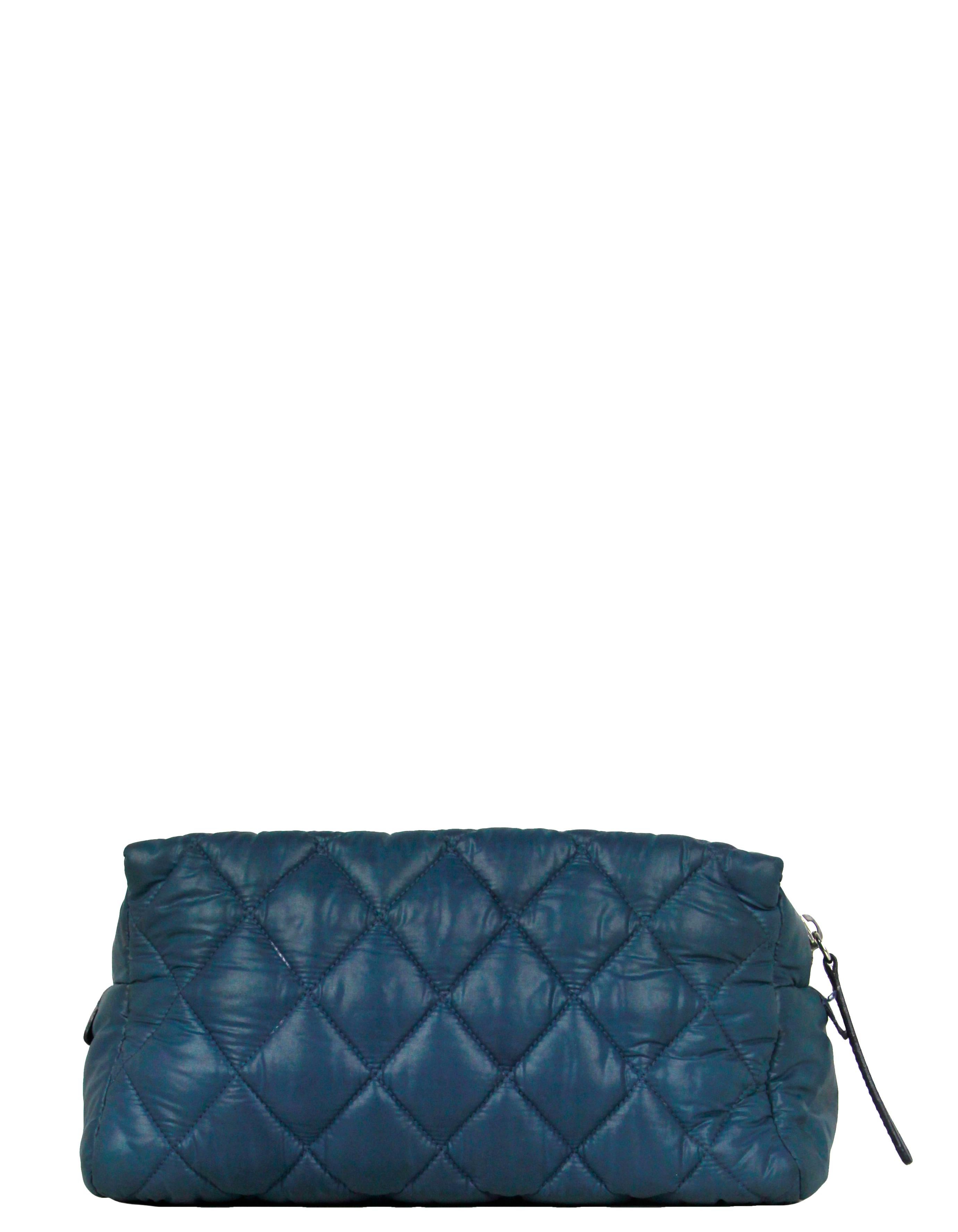 Chanel Blue Nylon Quilted Coco Cocoon Cosmetic Bag

Made In: Italy
Year of Production: 2009-2010
Color: Blue
Hardware: Silvertone
Materials: Nylon with leather trim
Lining: Black nylon
Closure/Opening: Zip top
Exterior Pockets: Front zip 
Interior