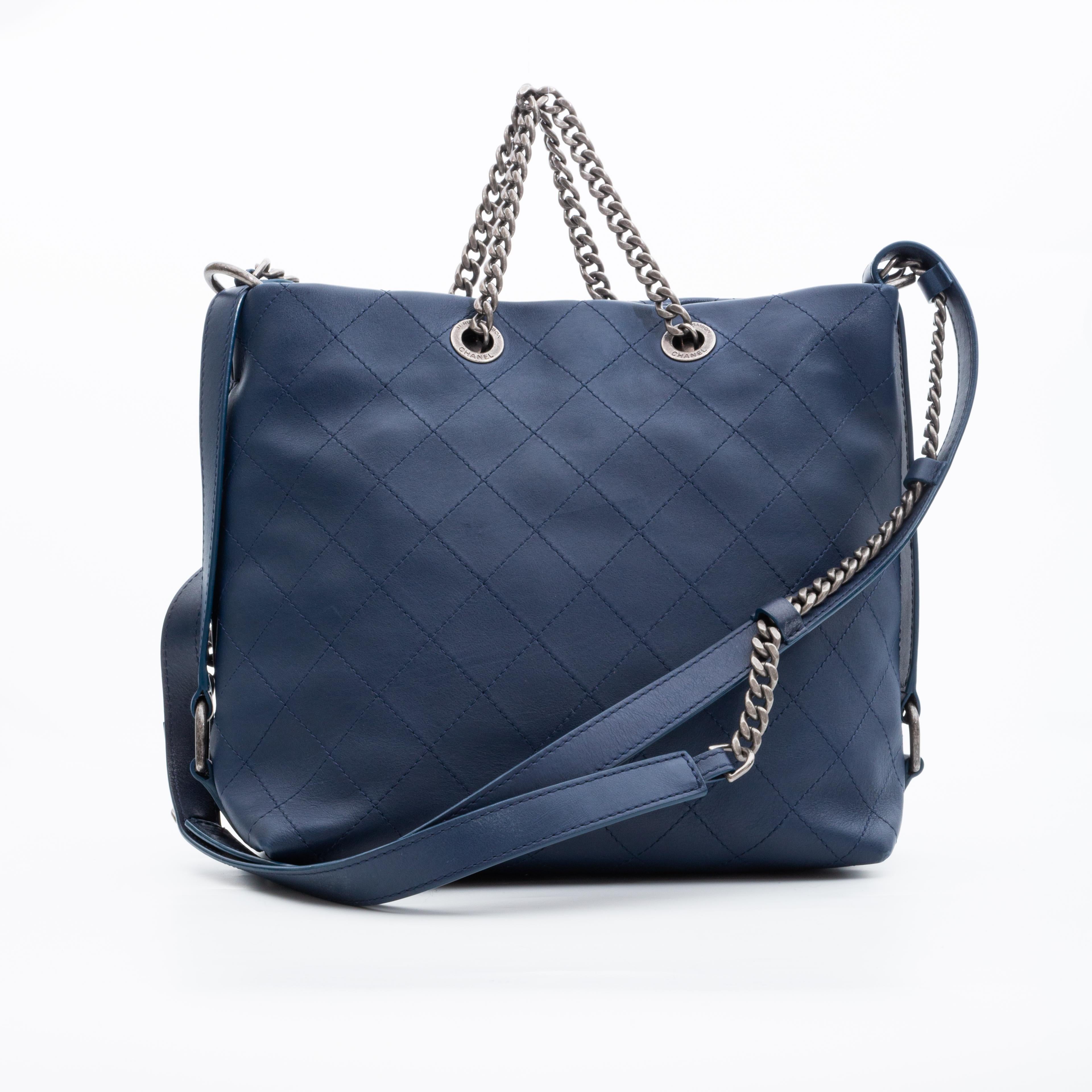 From the 2017 collection. This Chanel hobo bag is made with soft quilted calfskin leather in blue with a slouching shape. The bag features ruthenium (gunmetal) hardware, a long flat leather shoulder or cross-body strap, chain top handles, a dangling