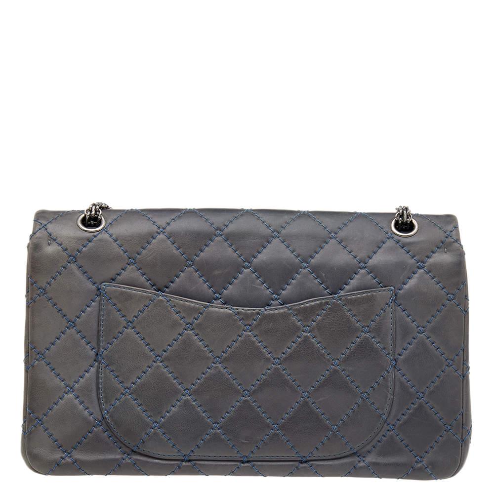 This Reissue 2.55 Classic 227 Double Flap bag from the House of Chanel is a beauty to behold. It is made from blue quilted leather, with a logo embellishment on the front. It has silver-tone hardware, a leather-lined interior, and a sturdy chain