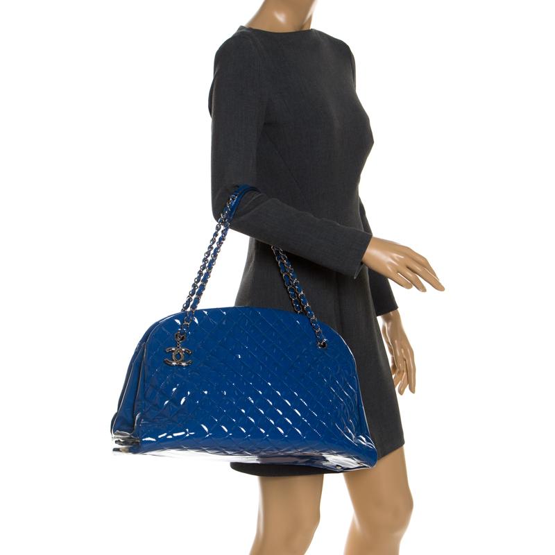 Spacious and captivating, this Just Mademoiselle bag is from Chanel. It has been crafted from blue patent leather and features the iconic quilted pattern. It is equipped with two chain handles and a well-sized fabric interior to keep your essentials