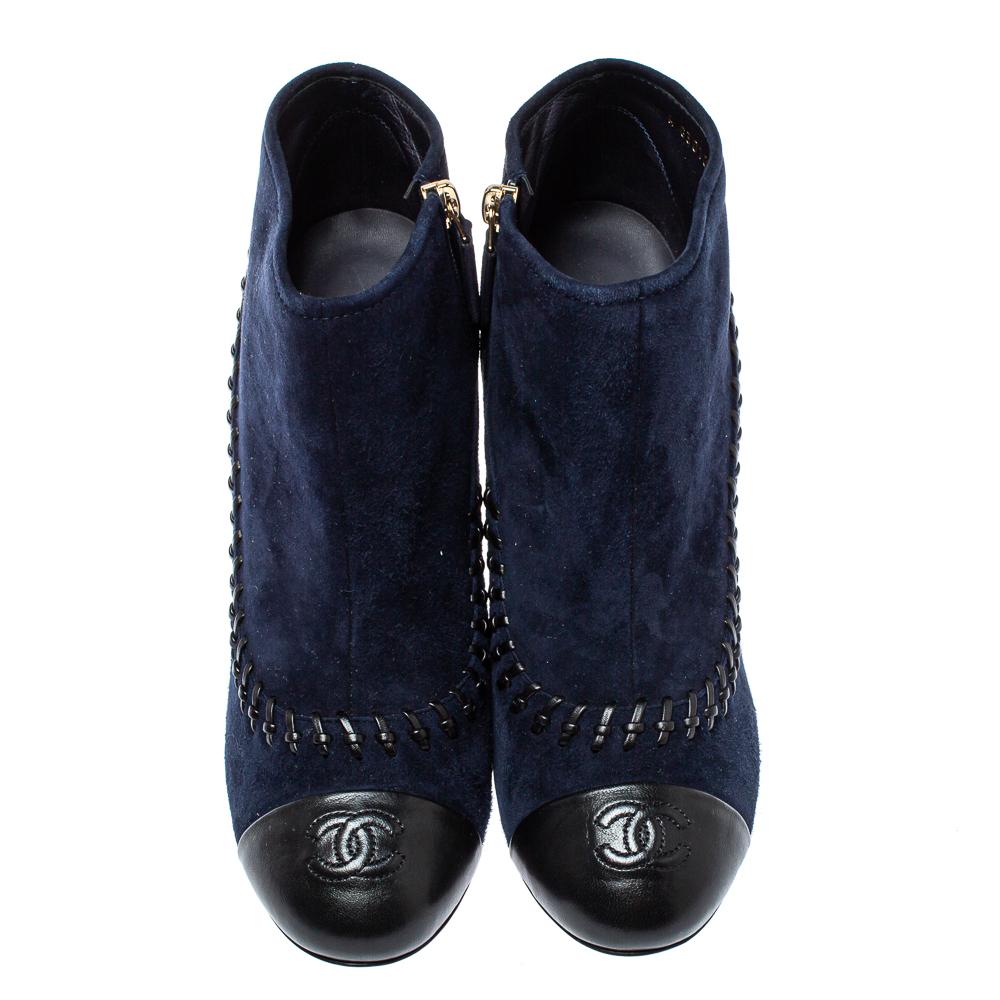 These stylish ankle boots hail from the house of Chanel. They have been crafted from plush suede and leather and come in a lovely shade of blue. They are styled with cap toes carrying the CC logo, whipstitch detailing, side-zip closure, and 11 cm