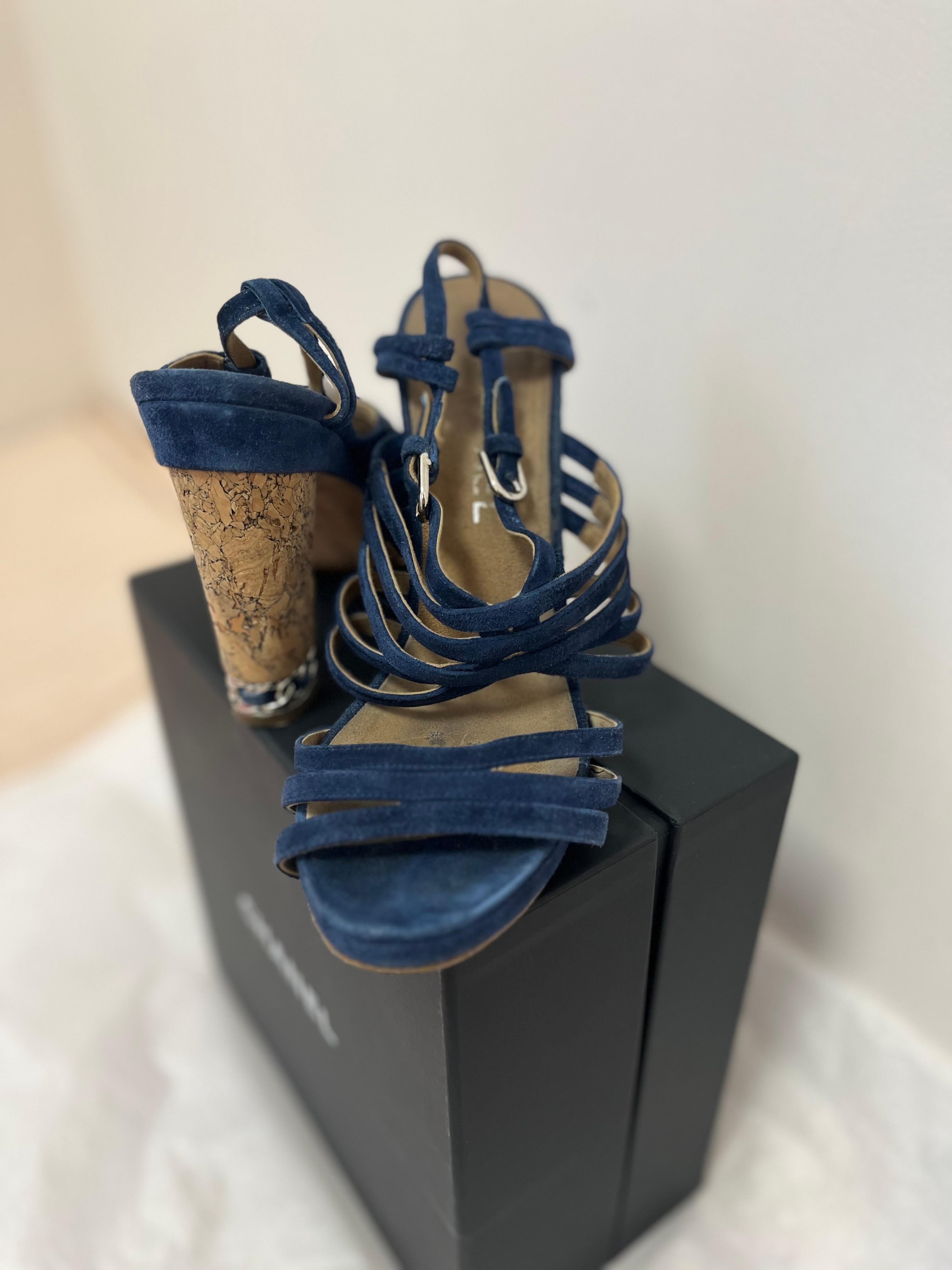 Elegant Chanel blue suede sandals/shoes in good condition. The wear is on the soles. Although they have heels these are very comfortable. The heels are made of cork with braided silver-tone metal and and blue suede at the bottom. There are also 