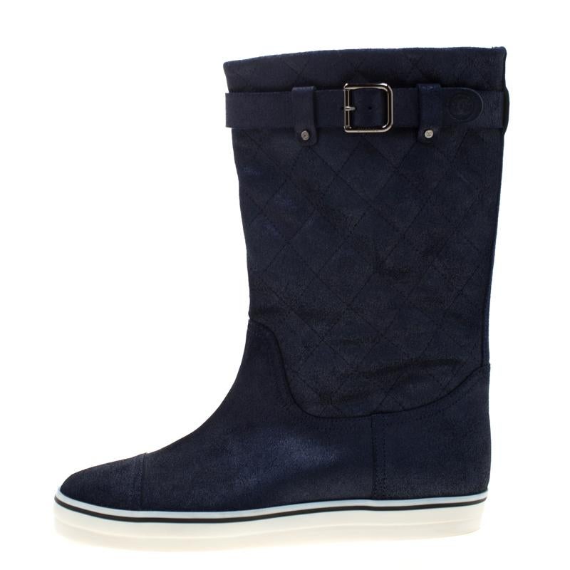 Stay on style with this pair of blue boots from Chanel! Beautifully crafted from textured quilted leather, these mid-calf boots carry round toes, leather insoles and belt details. Waltz around town in this lovely pair!

Includes: Original Dustbag

