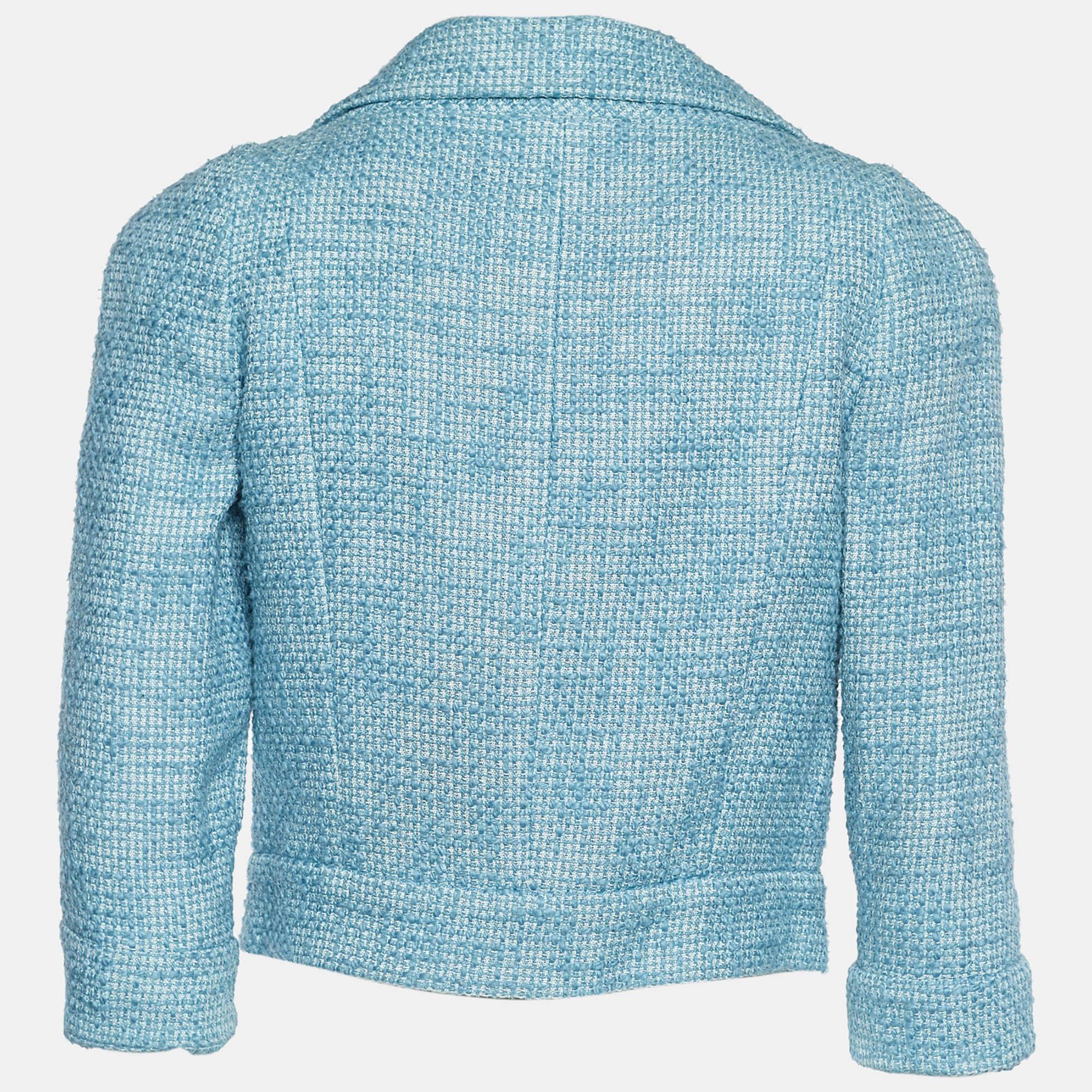 Experience the charming vibe of celebrities and vintage art with this jacket from Chanel. Featuring a cropped silhouette, blue tweed fabric, and decorative button embellishments, this Chanel creation pays an ode to a never-aging style. It carries