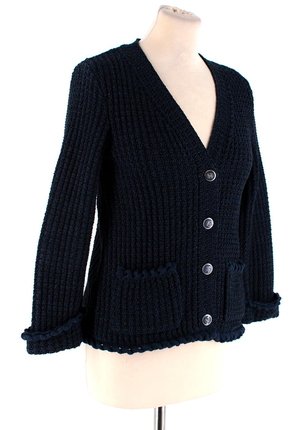 Chanel Blue Tweed Ruffled Button Down Cardigan 

- Classic Chanel tweed design 
- Thick knitted cardigan 
- Cotton/Silk/Cashmere blend 
- CC embossed silver coated buttons 
- Front patch pockets
- Ruffled sleeves and pocket trims

Materials: 
62%