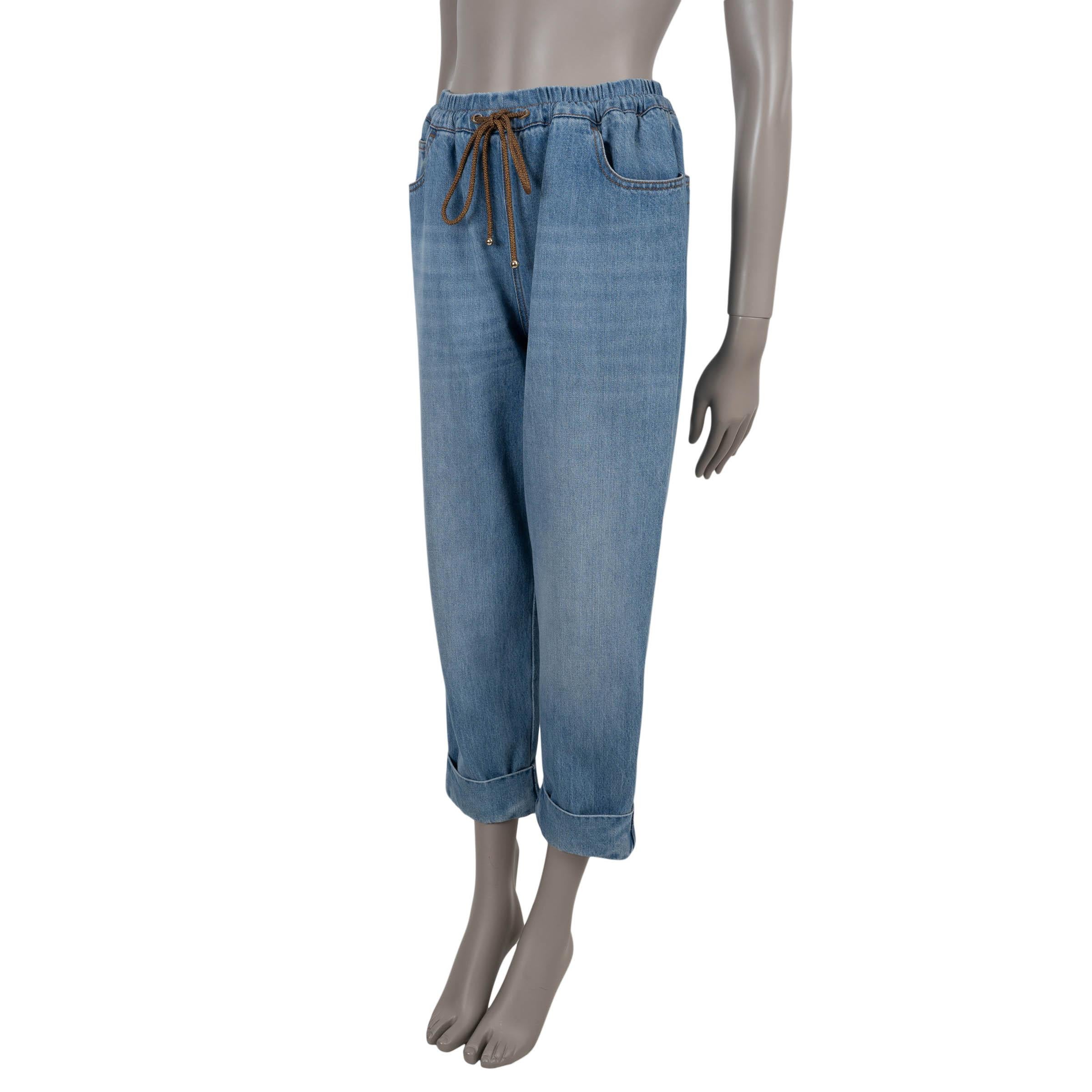 This 100% authentic Chanel boyfriend jeans are crafted in washed blue denim cotton (100%), offering a relaxed silhouette with wide legs that taper slightly into cuffed hems. The classic five-pocket design is accented by a signature CC detail on the