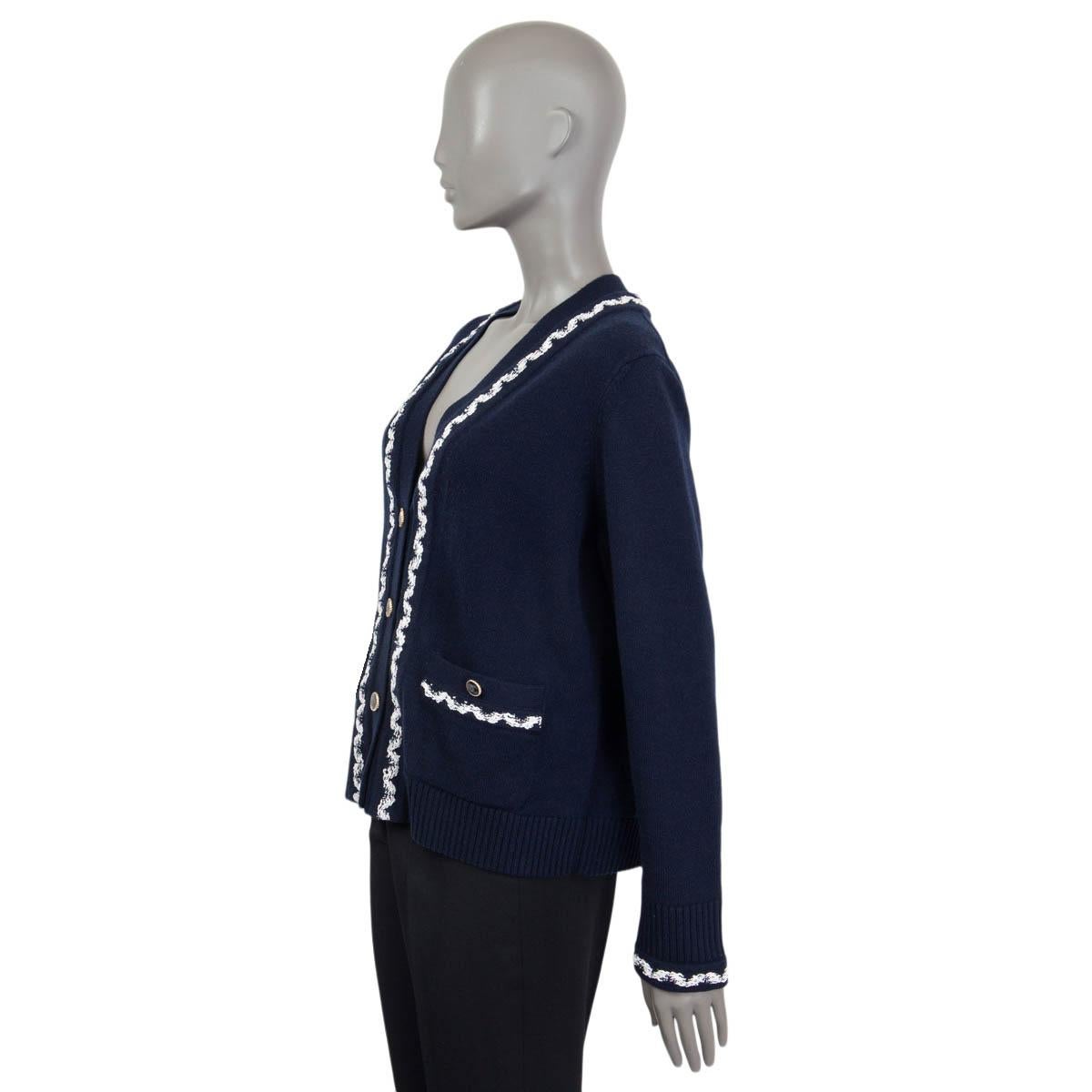100% authentic Chanel Pre Spring 2021 knit cardigan in navy blue and white cashmere (100%). Features two 'CC' buttoned patch pockets on the front. Opens with four 'CC' buttons on the front. Unlined. Brand new, with