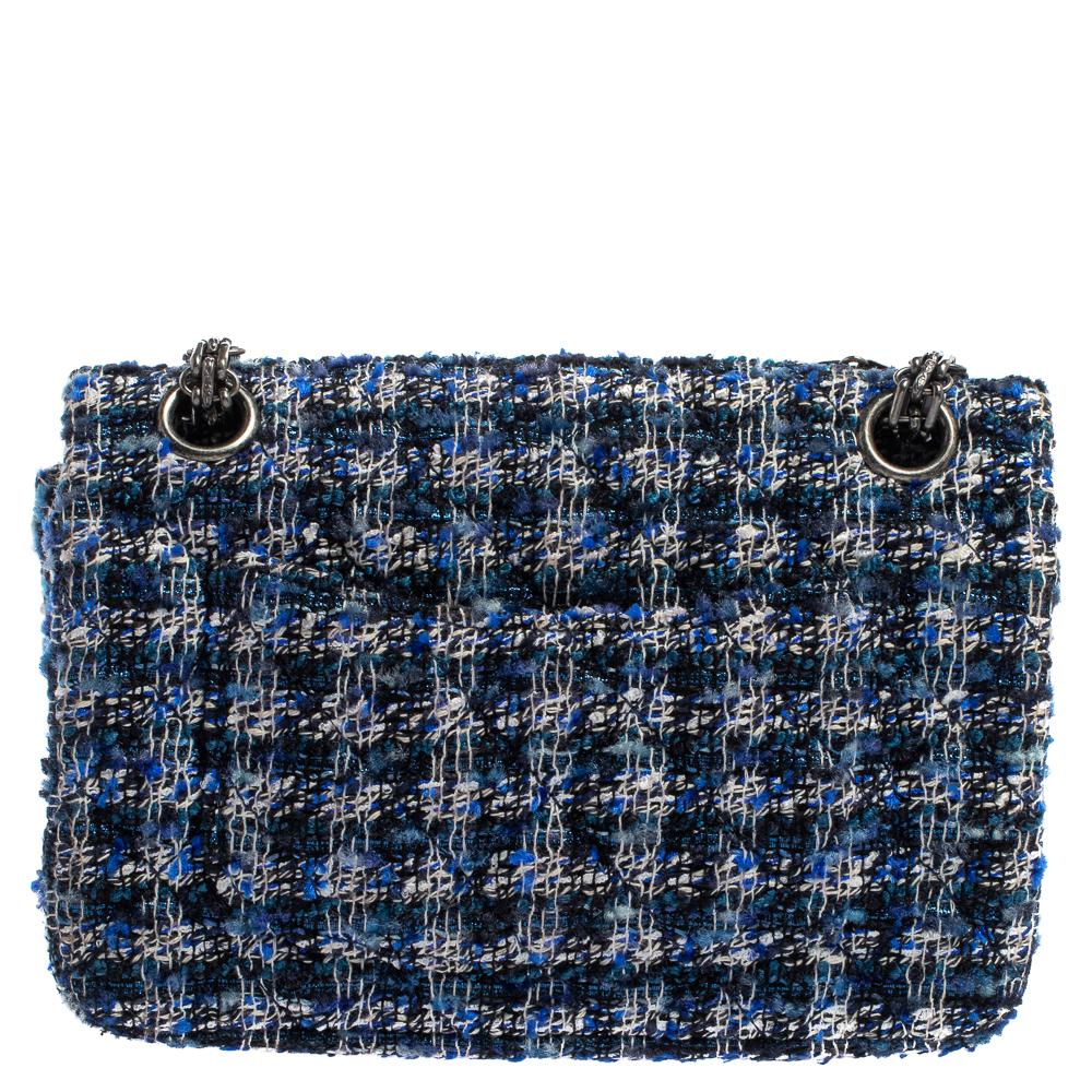 Chanel's Flap Bags are iconic and noteworthy in the history of fashion. Hence, this Reissue 2.55 is a buy that is worth every bit of your splurge. Exquisitely crafted from blue & white tweed, it bears its signature quilt pattern and the iconic