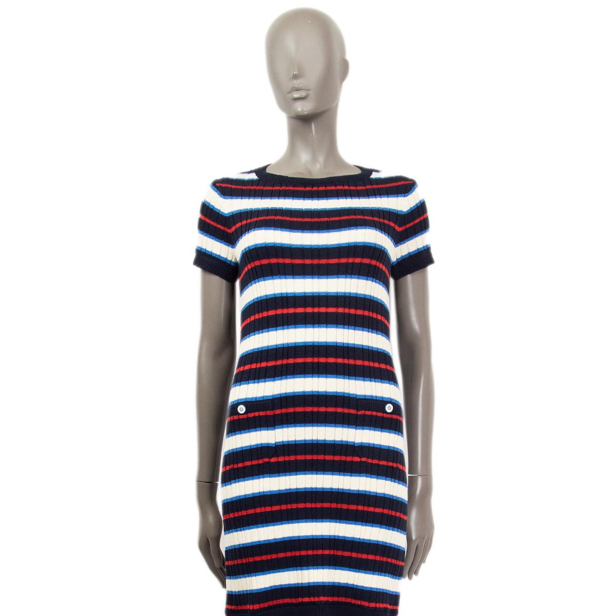 100% authentic Chanel short sleeve knit dress in white, blue, midnight blue and red cotton (96%) and silk (4%). Comes with two slit pockets on the front (still sewn shut). Slit pockets are embellished with white and blue CC buttons. Unlined. Has