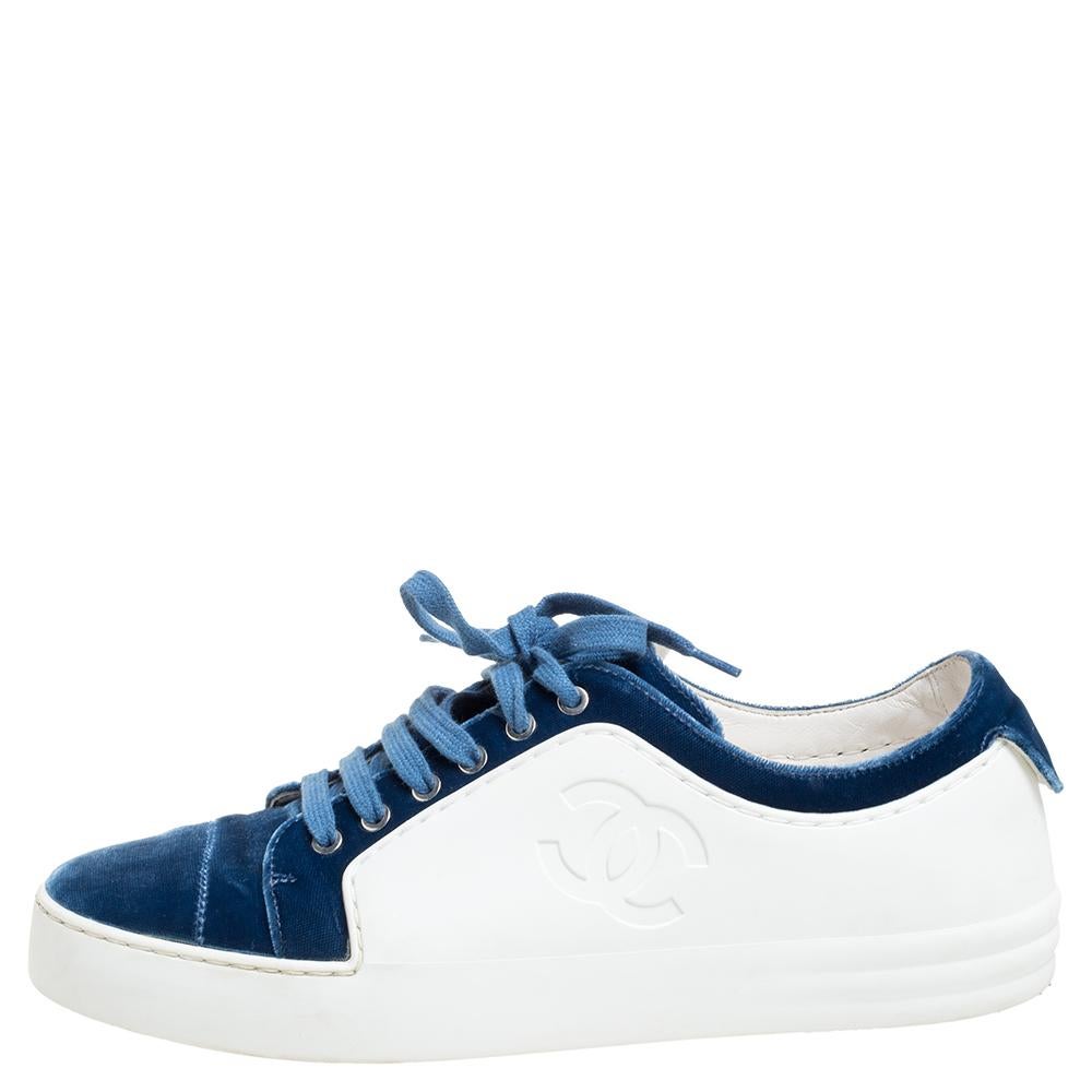 This classy and casual pair of low-top sneakers from Chanel is a must-have! The vamp and toe are made from plush blue velvet and the rest of the construction is white rubber. It flaunts the CC logos on the sides, lace-ups on the vamps, and is