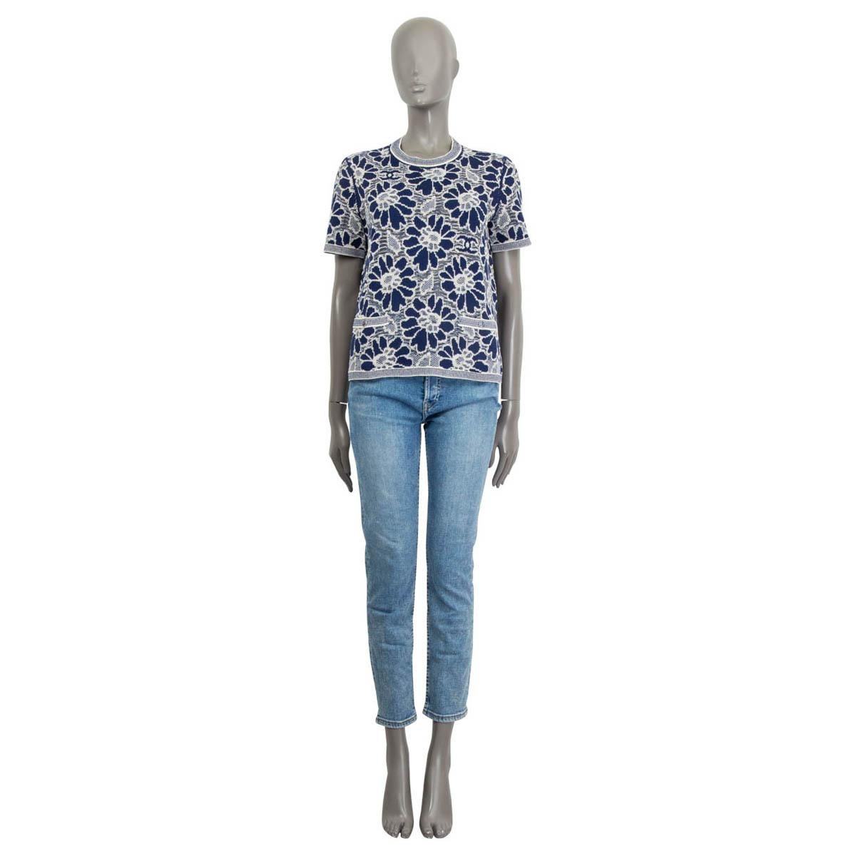 100% authentic Chanel Pre-Spring 2020 camellia knitted top in blue and off-white wool (51%), cotton (33%) and polyamide (16%). Features short sleeves and two sewn shut buttoned patch pockets on the front. Unlined. Has been worn once and is in