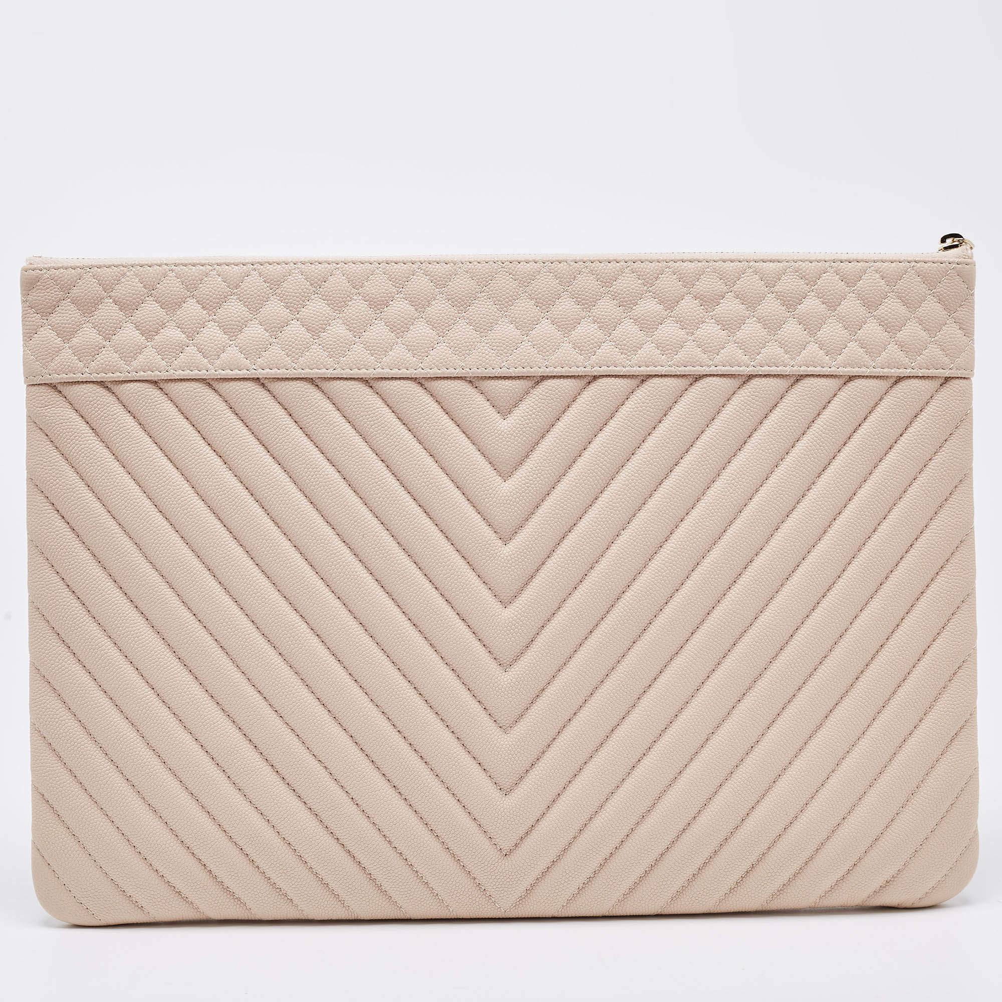 This pouch from Chanel will surely add glam to your style. Designed with a dash of blushed pink color, this pouch is crafted from leather and features chevron quilts. This sleek piece is handy and comes with a fabric-lined interior that is secured
