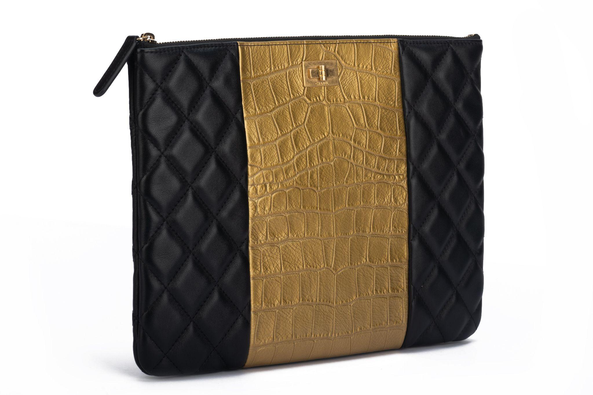 Chanel new black quilted and gold croc embossed leather clutch. Collection 28. Comes with hologram, di card, dust cover and box.
