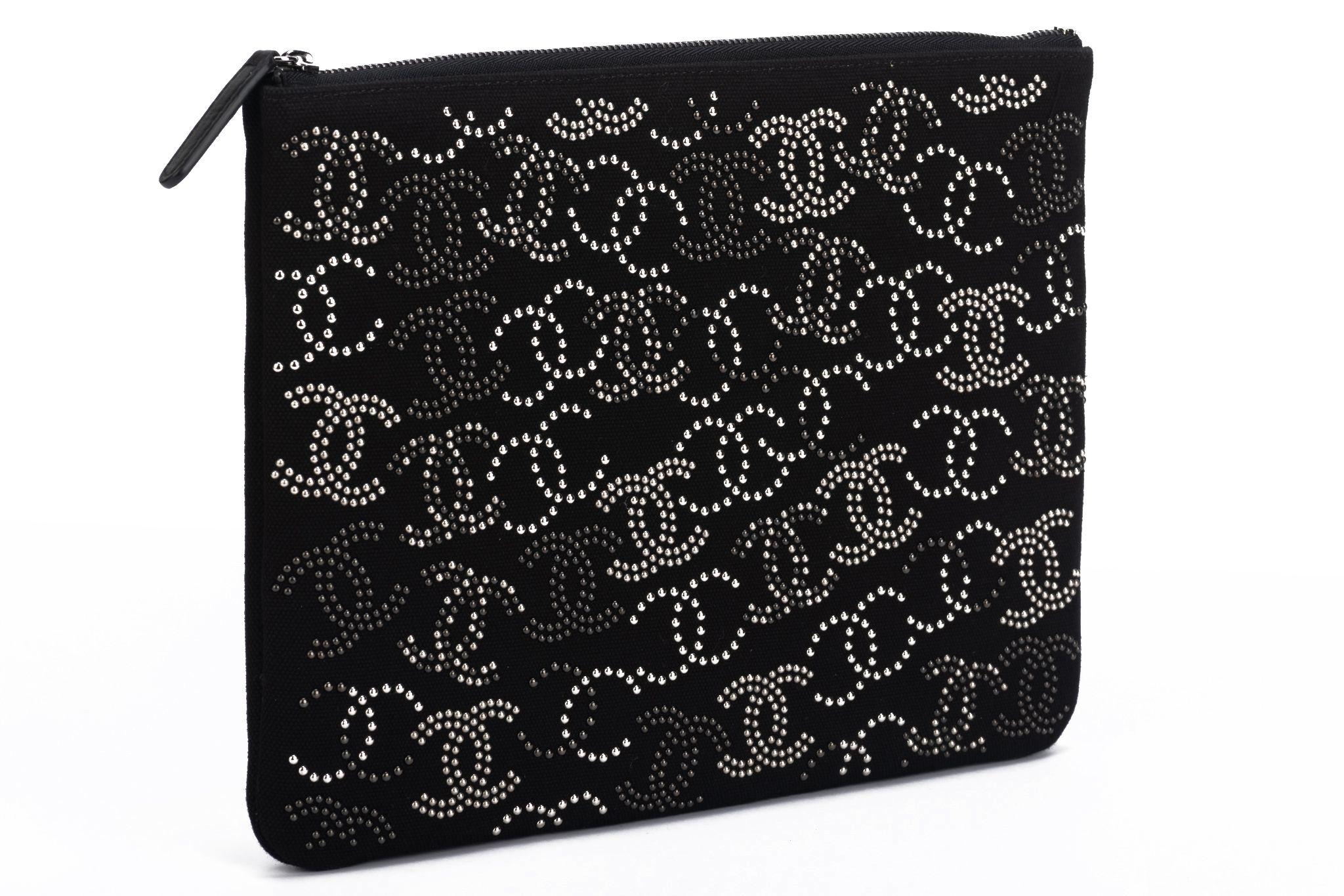Chanel new black fabric clutch with multiple studded cc logos. Collection 27. Comes with hologram, ID card , original dust over and box.

