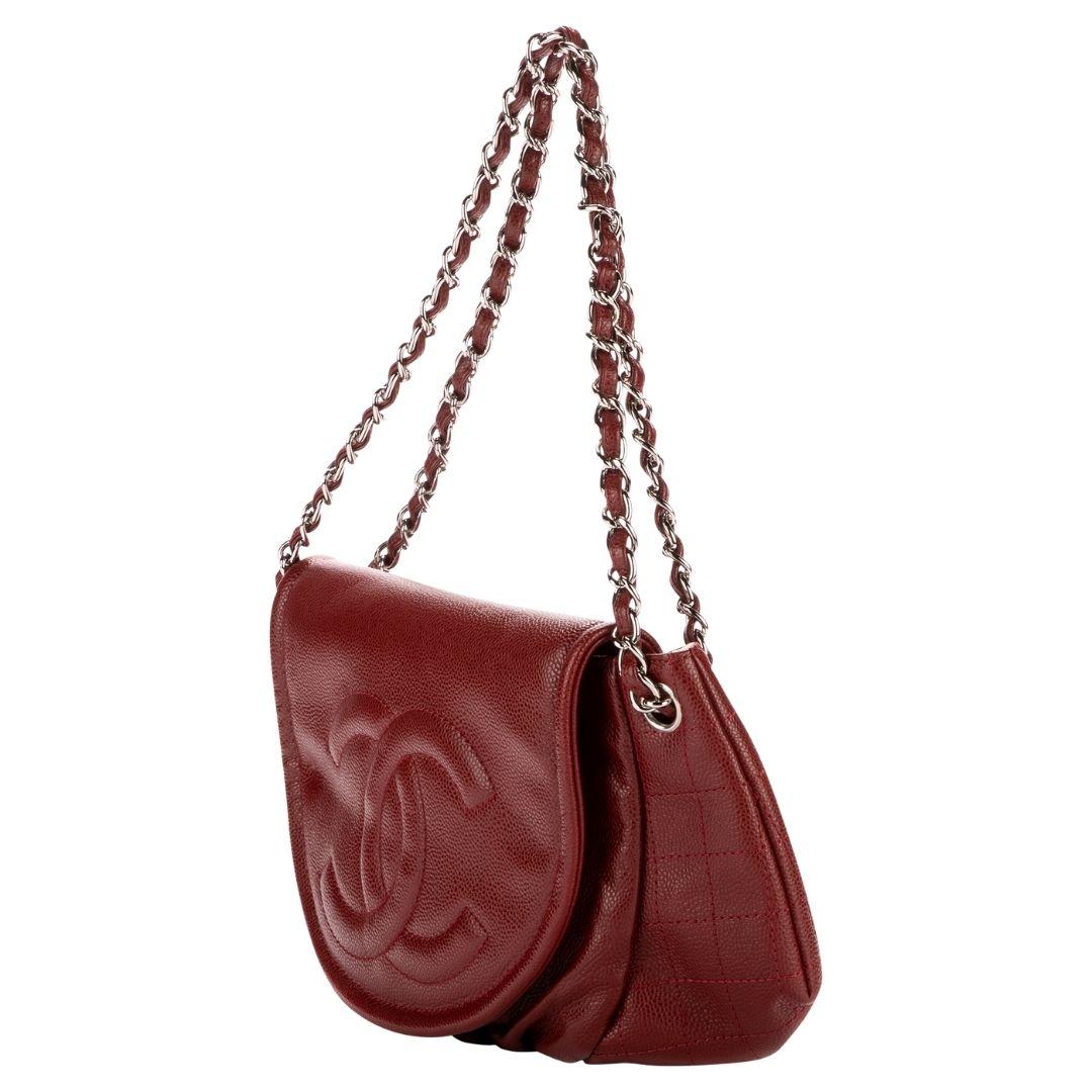 Karl Lagerfeld's vision for Chanel is embodied in this bordeaux caviar leather CC flap bag. A silver-tone magnetic snap reveals a twill interior with both zippered and slip pockets for essentials.

SPECIFICS
Length: 14.6