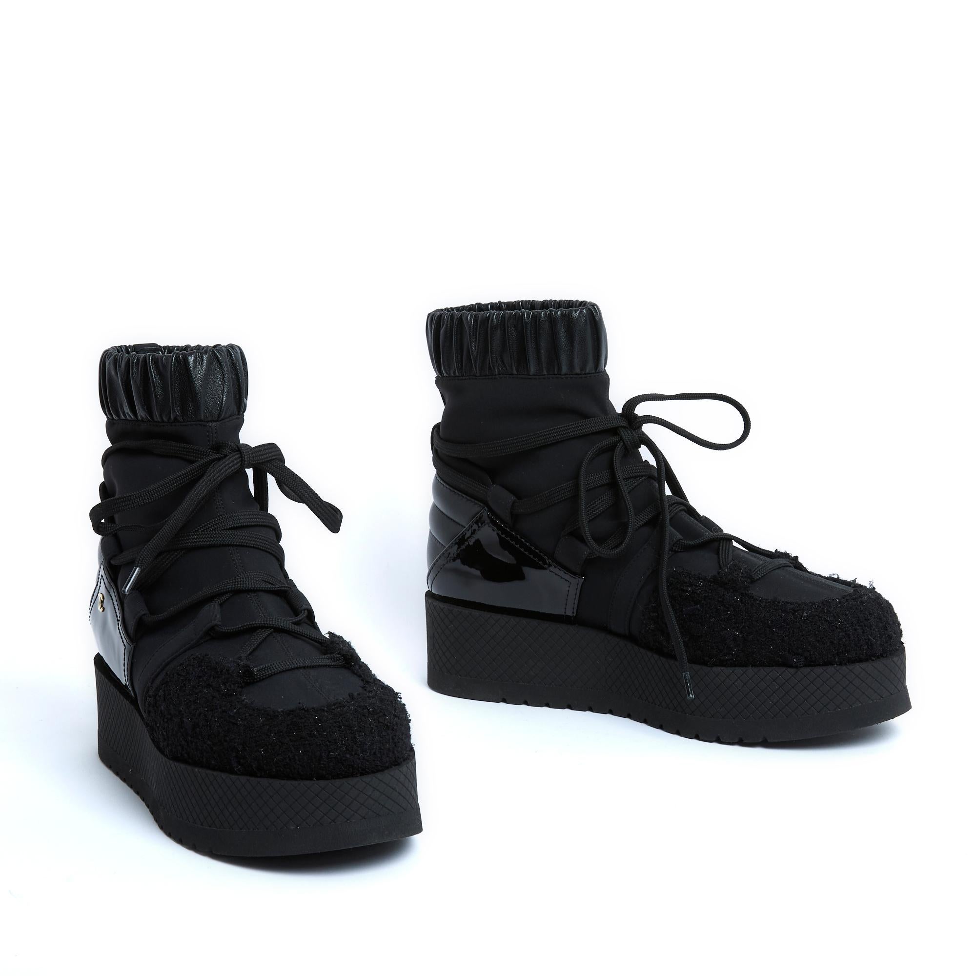 Chanel Coco neige mid-high sock-style ankle boots in leather, polyamide, patent leather and black shimmering tweed, 5-loop tightening lace, rounded toe, thick black rubber notched sole with quilted effect around the edge, leather lining and insole.