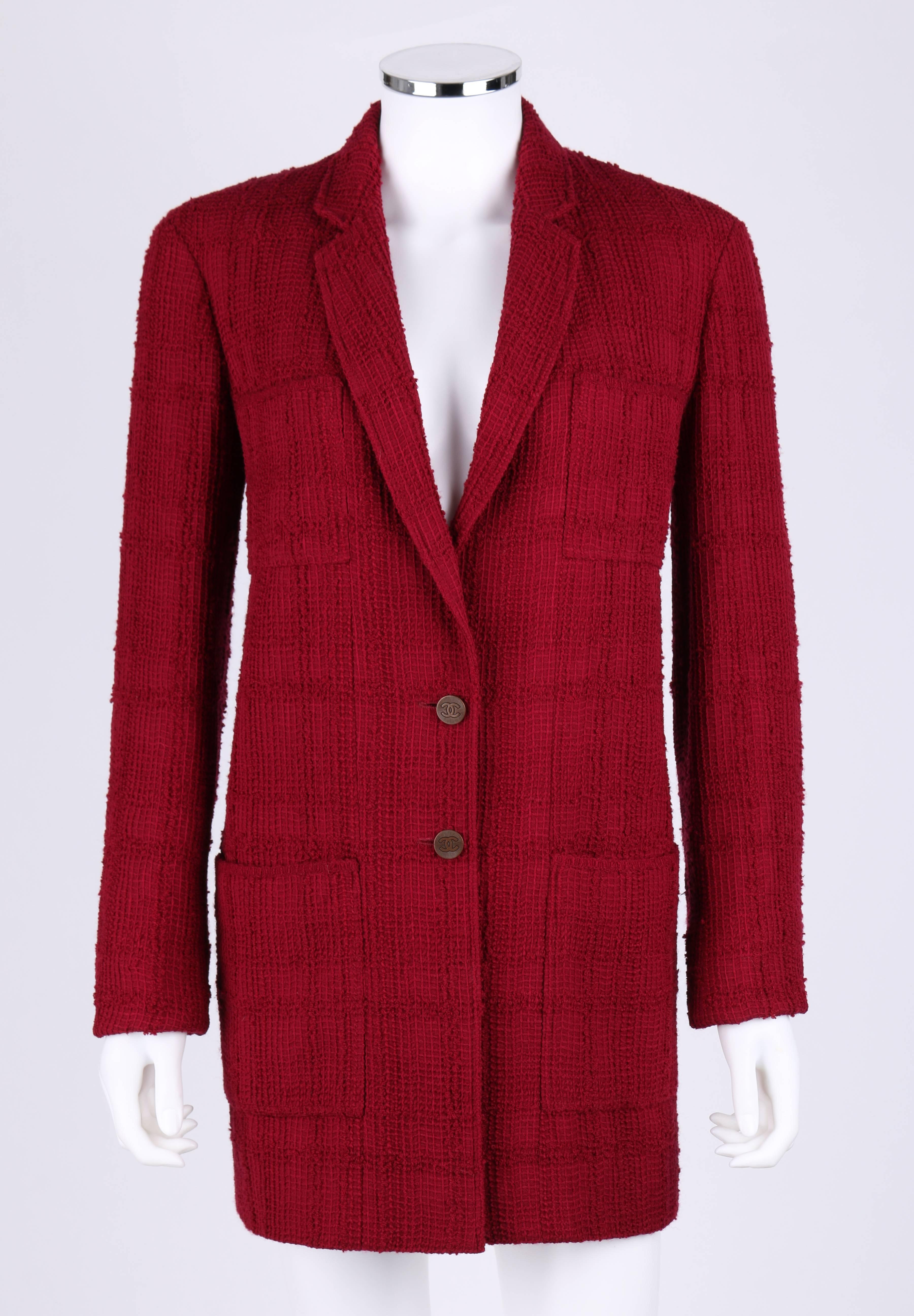 Chanel Boutique Autumn/Winter 1998 garnet red plaid boucle wool two button jacket / blazer with belt. Designed by Karl Lagerfeld. Wine red large plaid boucle pattern over top a loose waffle weave. Notched lapel collar. Long sleeves. Two center front