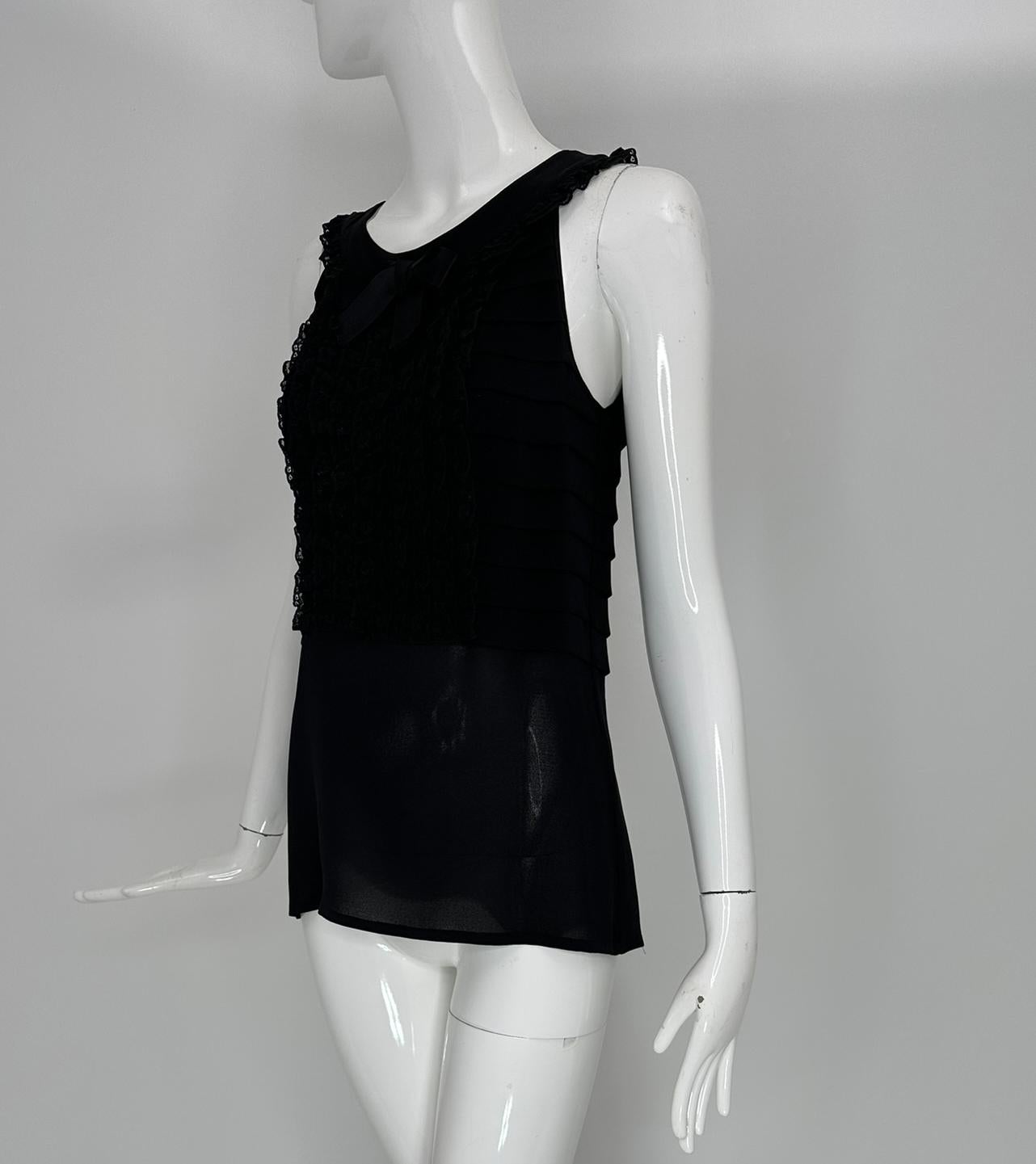 Chanel Boutique Nero Pizzo Pettorina Collo Fiocco Plissettato Top Senza Maniche Piccolo
Chanel Boutique in pizzo nero, pettorina frontale, collo a fiocco, top senza maniche a pieghe. Il top aperto a girocollo è senza maniche e rifinito in pizzo,