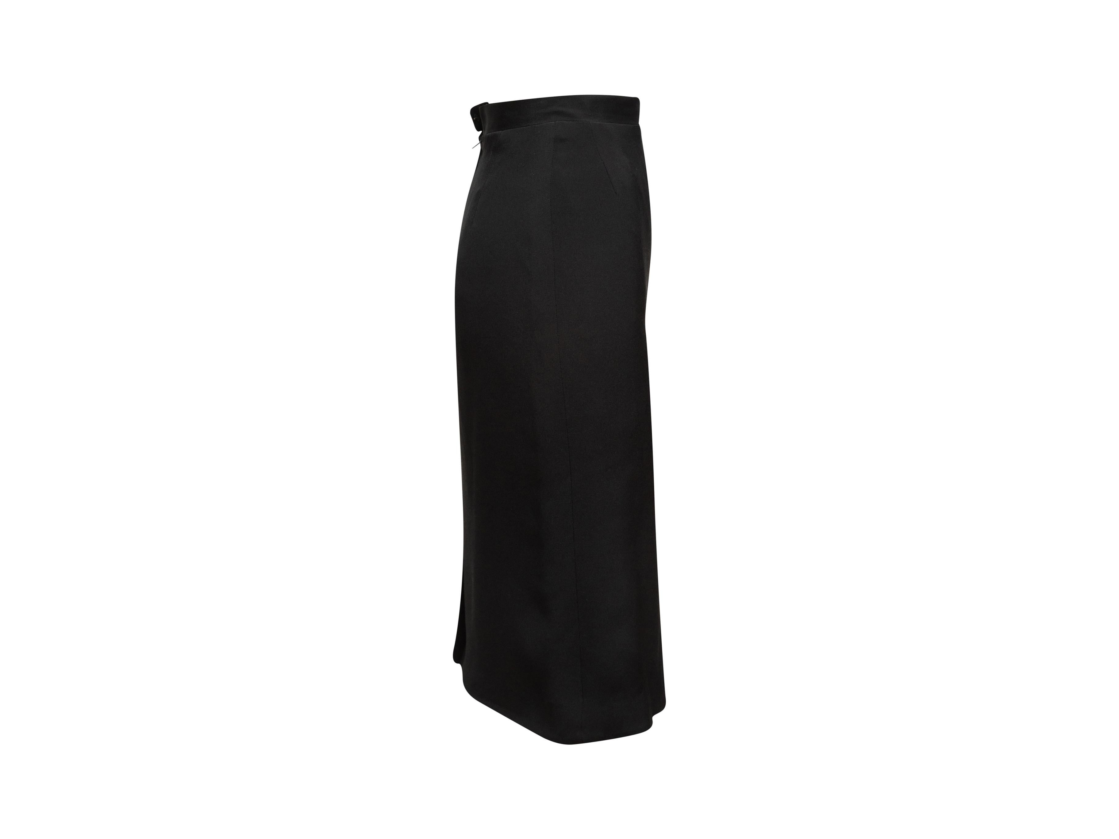 Product details: Vintage black knee-length pencil skirt by Chanel Boutique. Vent at back hem. Concealed zip and hook-and-eye closures at center back. Designer size 36. 24