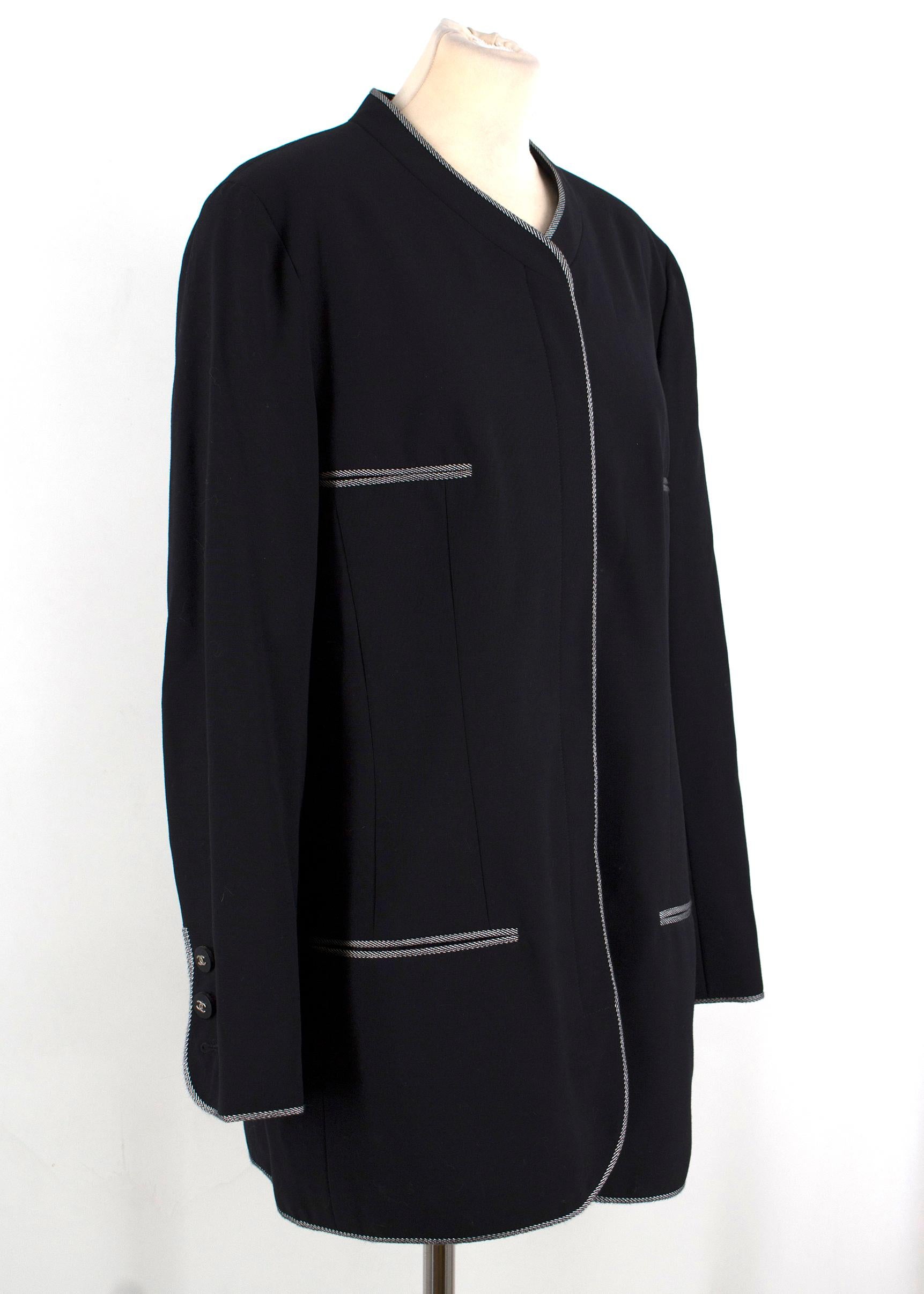 Chanel Boutique Collarless Wool Blazer

- 100% wool 
- Collarless
- Concealed button front fastening
- Contrast stitching around neckline down to the hems, sleeve cuffs and pocket openings
- Exposed buttoned cuffs with black plastic buttons embossed