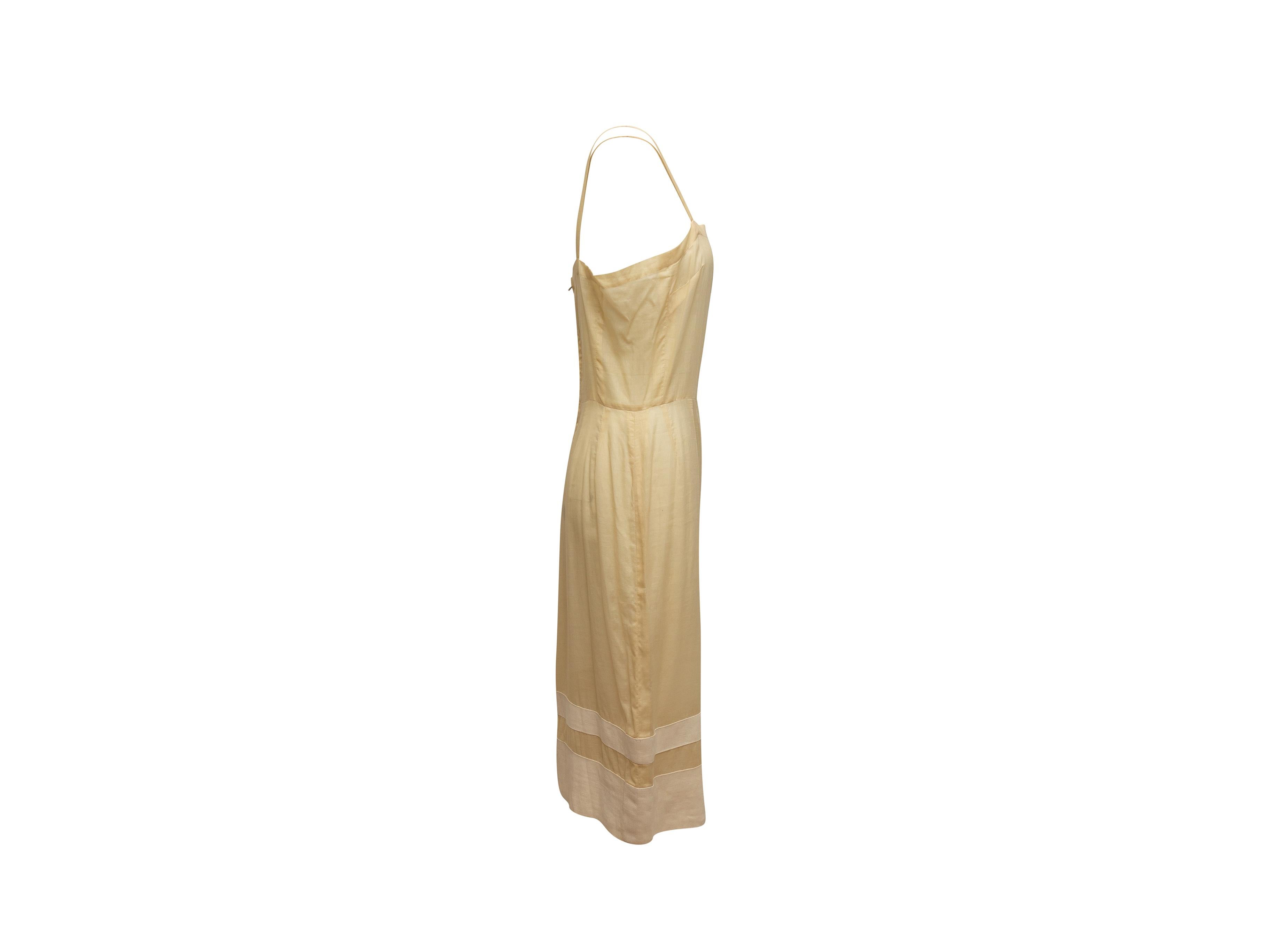 Product details: Vintage cream sleeveless dress by Chanel Boutique. Square neckline. Narrow straps. Zip closure at back. 36