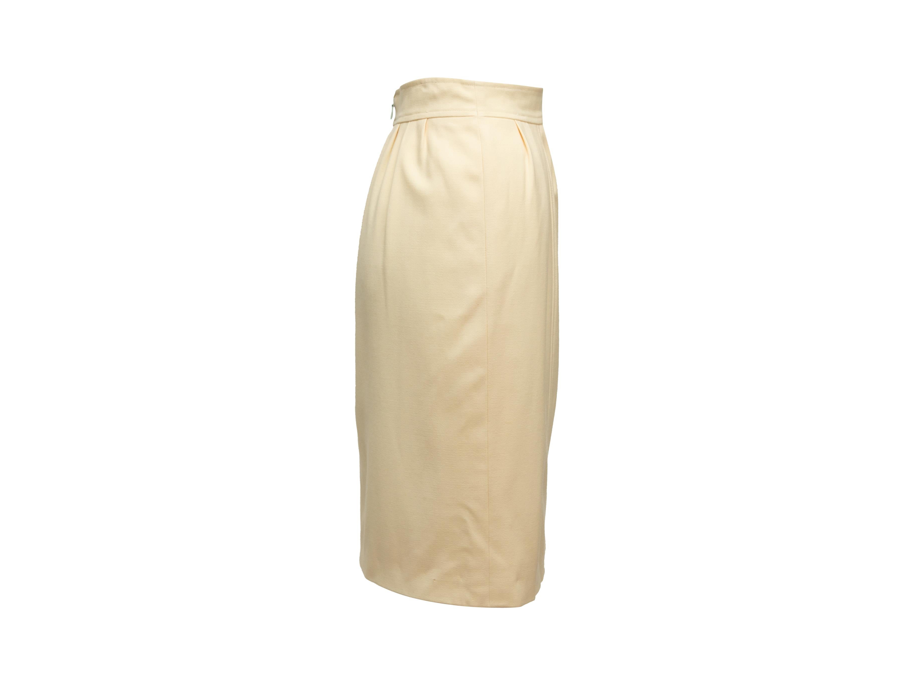 Product details: Vintage cream wool knee-length skirt by Chanel Boutique. Concealed zip closure at center back. Designer size 40. 28