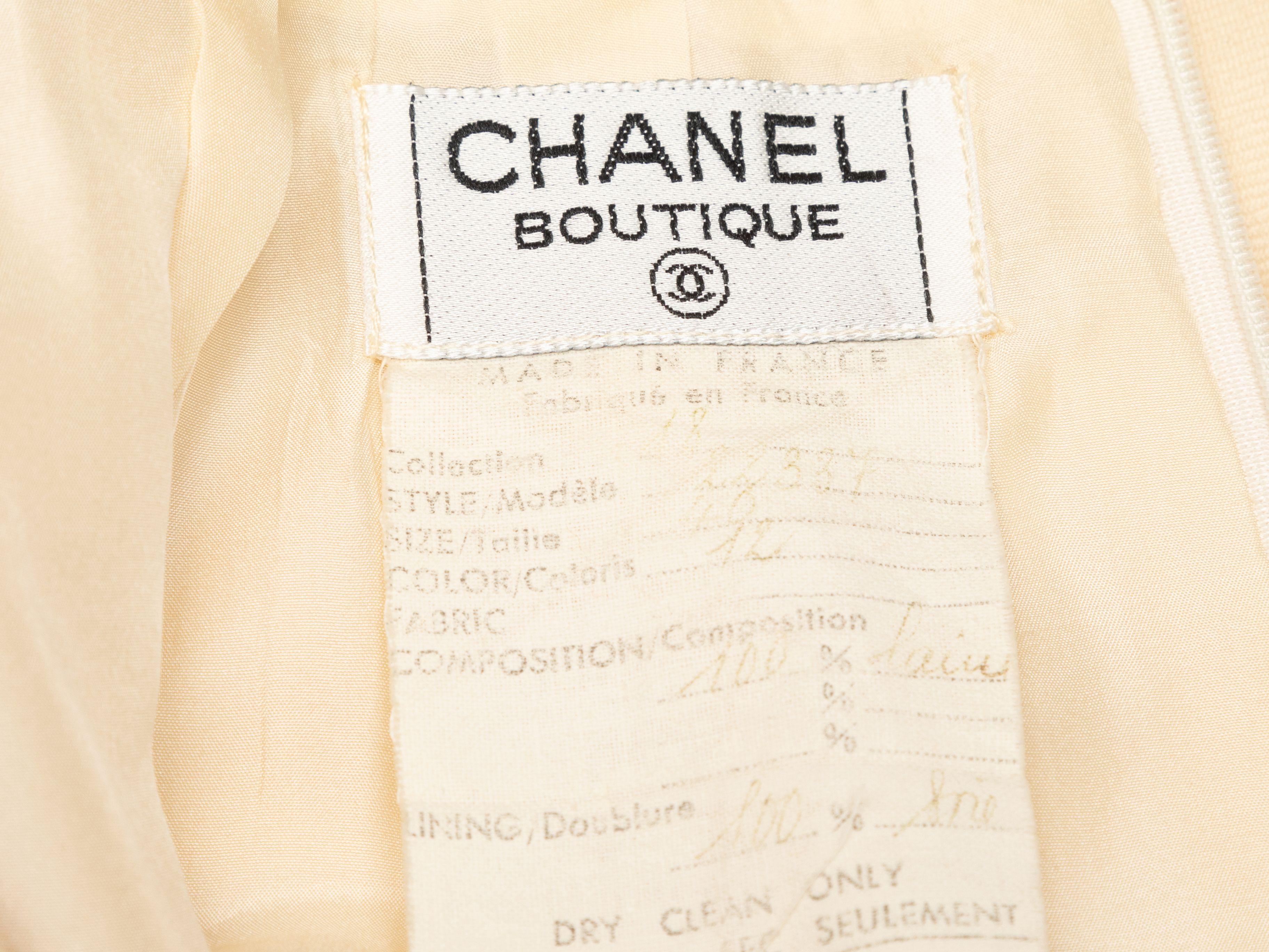Product Details: Vintage cream wool knee-length skirt by Chanel Boutique. Pleating at waist. Zip closure at back. 30