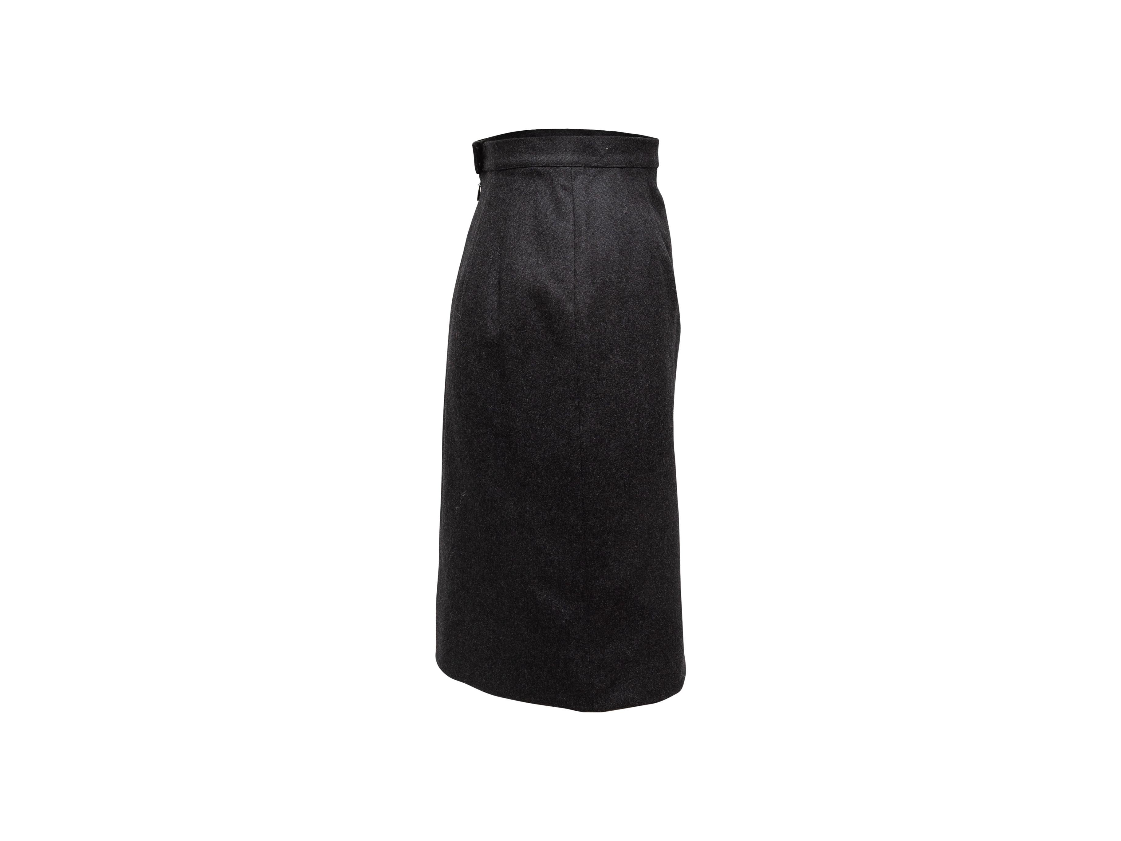 Product details: Vintage dark grey wool pencil skirt by Chanel Boutique. Concealed zip and gold-tone CC button closures at center back. Designer size 36. 25