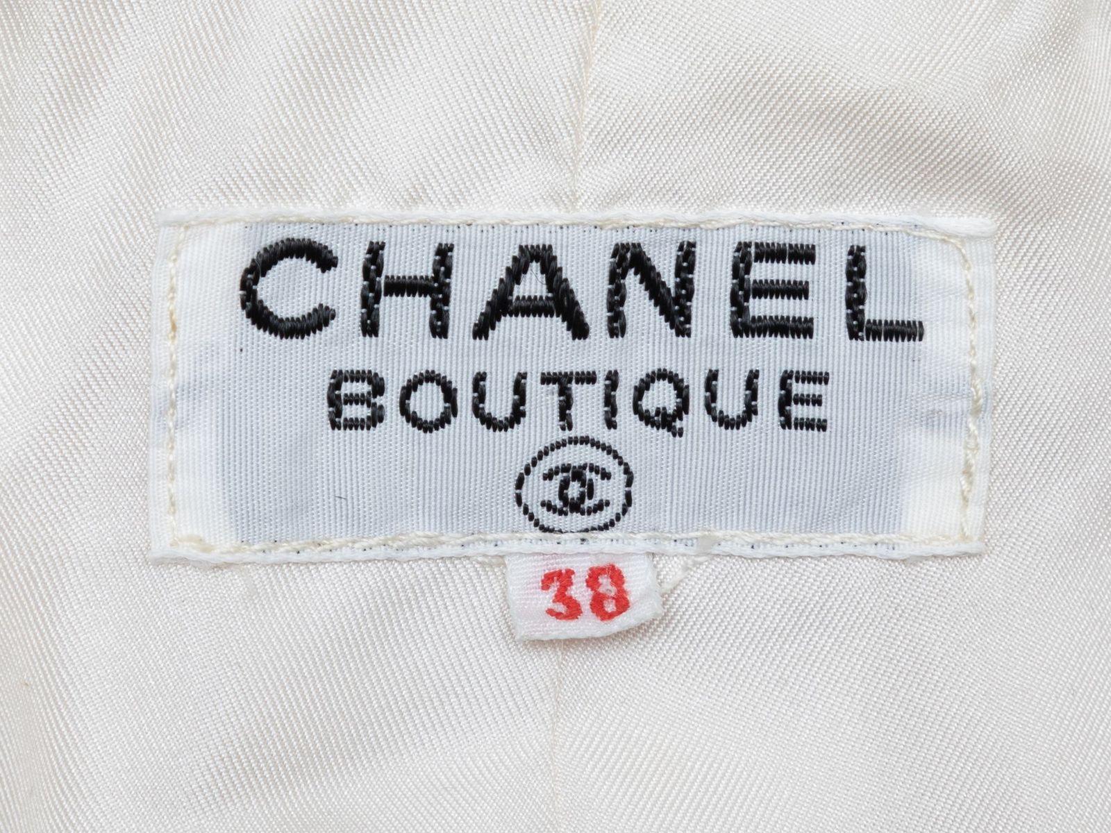 Product Details: Vintage ivory boucle tweed jacket by Chanel. Gold-tone hardware. Dual hip pockets. Open front. Designer size 38. 34