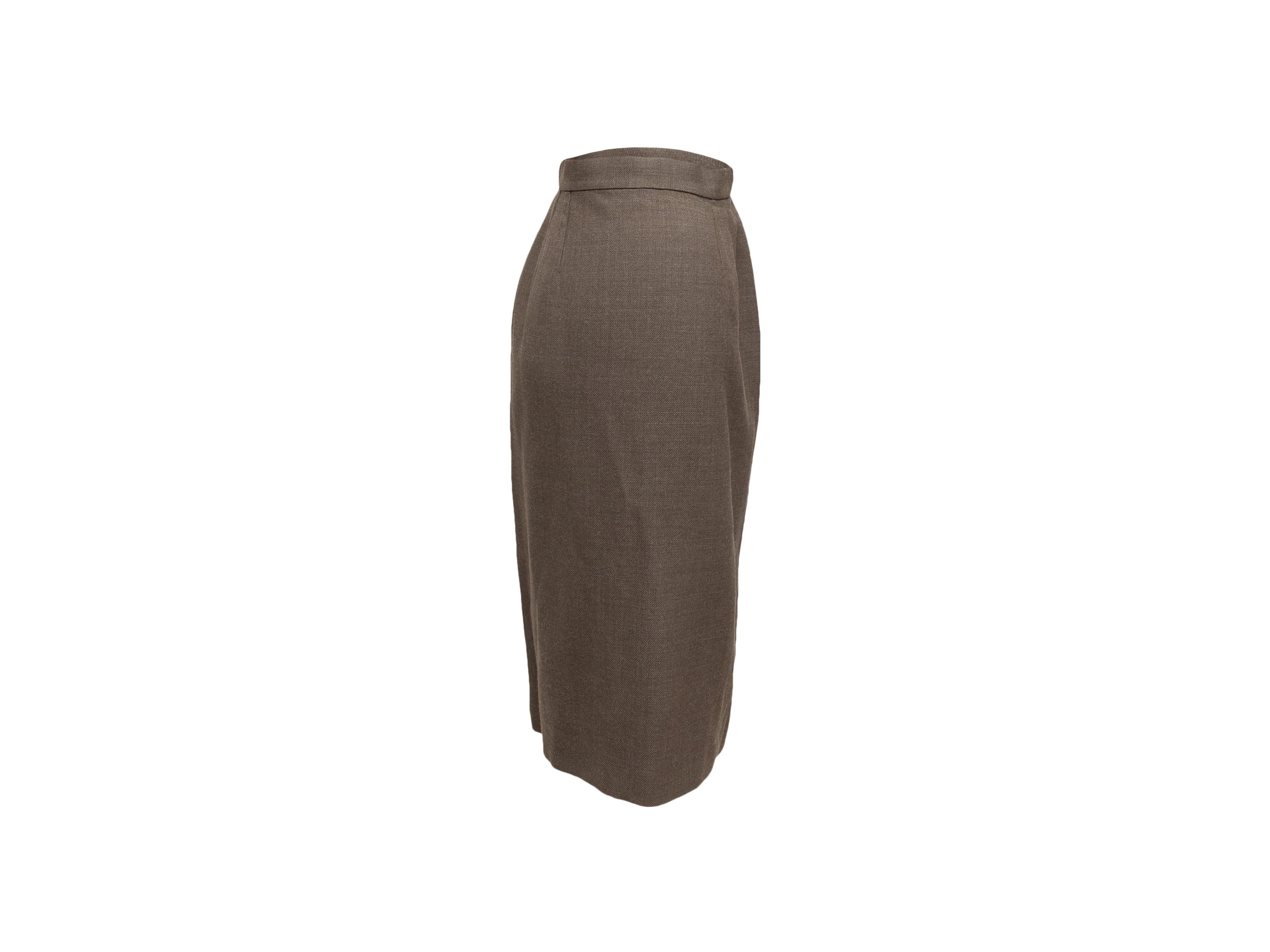 Product details: Vintage light brown wool knee-length skirt by Chanel Boutique. Concealed zip and gold-tone CC button closures at side. 27