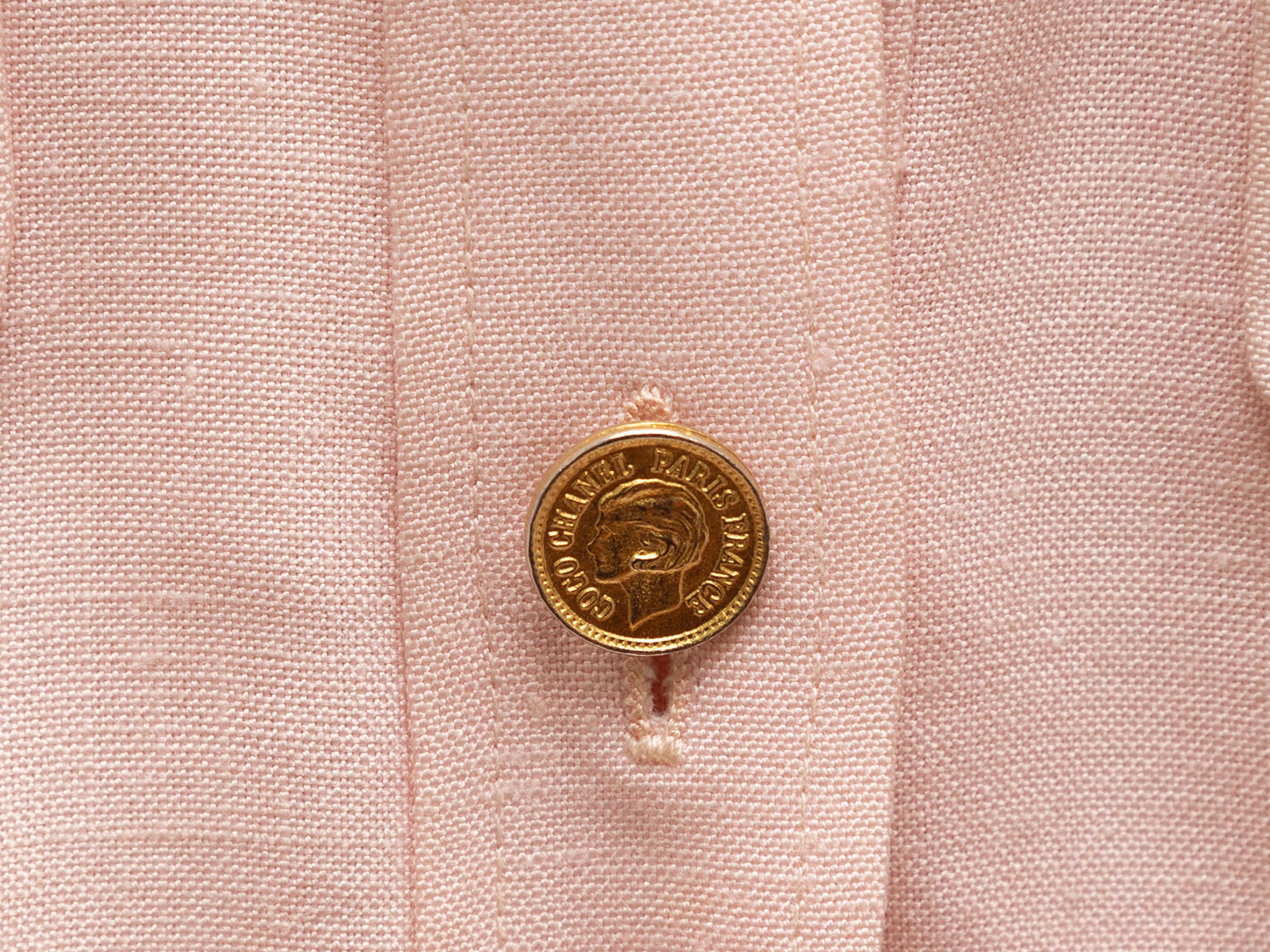 Product details: Vintage light pink V-neck jacket by Chanel Boutique. Dual flap pockets at bust. Gold-tone button closure at front. Designer size 42. 40