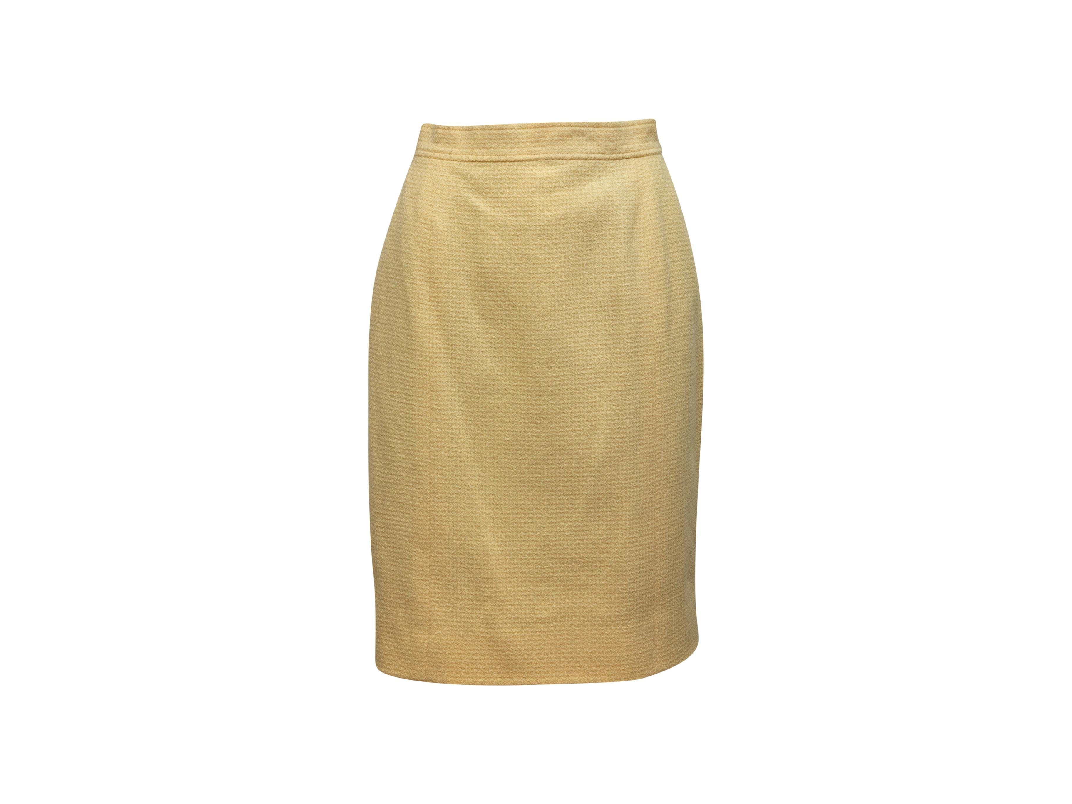 Product details: Vintage light yellow wool tweed skirt by Chanel Boutique. Zip closure at back. 28