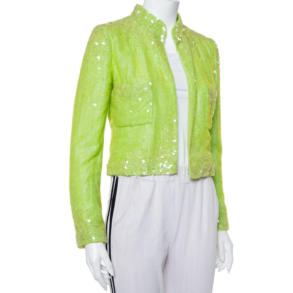 Your everyday wardrobe will now get a stylish update with this cropped jacket from Chanel Boutique! The lime green creation is made of velvet and features an open front design and a flattering silhouette. Embellished with sequins all over, it comes