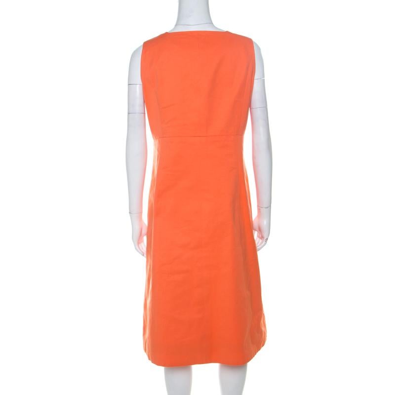 This lovely dress from Chanel proves that simplicity is the ultimate sophistication! The orange dress features a chic silhouette and is enhanced with silver-tone buttons in a double breasted style on the front. It flaunts a square neckline and is