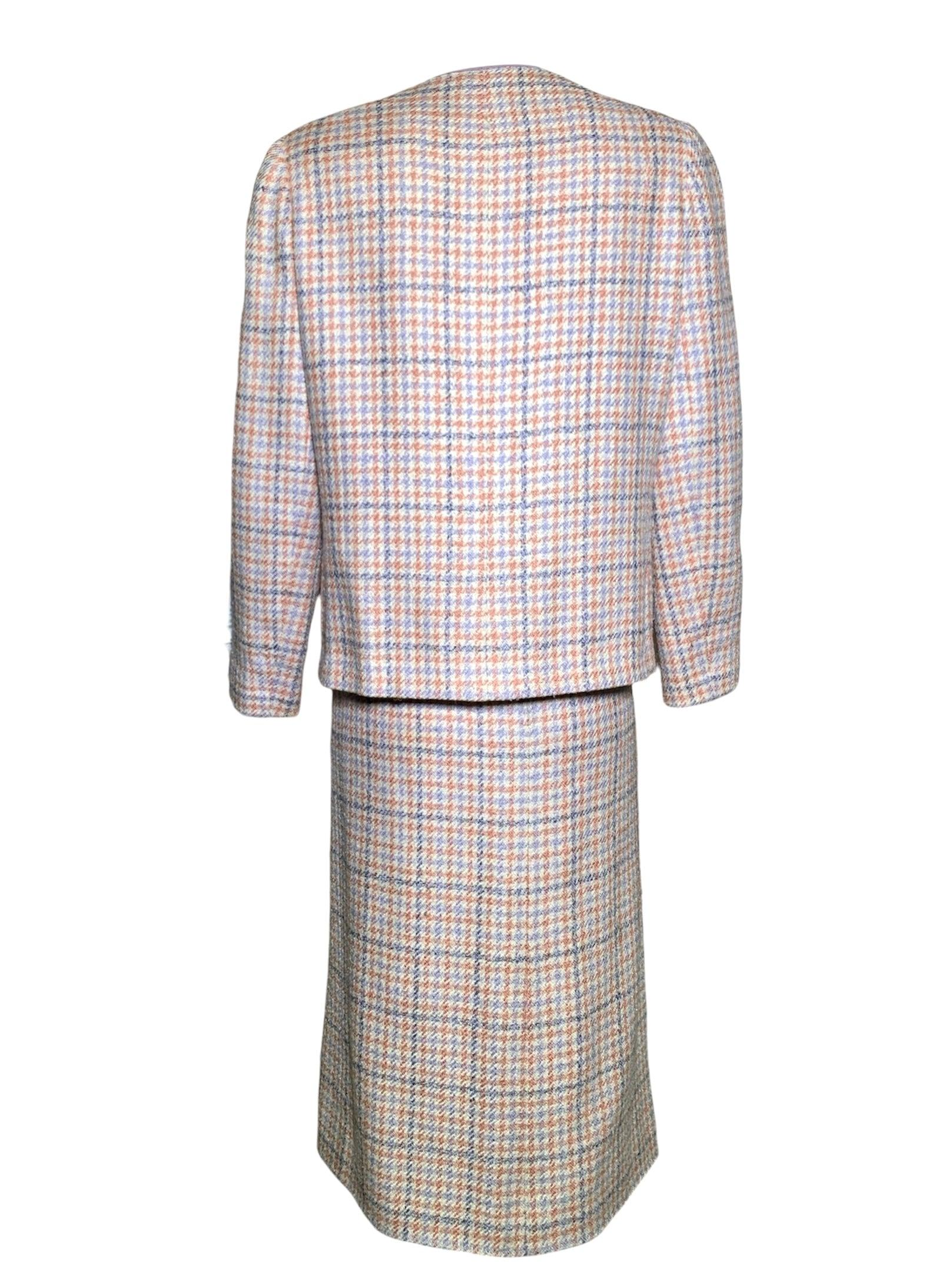 Chanel Boutique houndstooth skirt suit circa 1990's. Quintessential ultra feminine Chanel muted pastel color palette. Powdery salmon pink, lilac, lavender, and cream houndstooth. Silk wool blend. Fully lined in silk. Very light shoulder pads for the