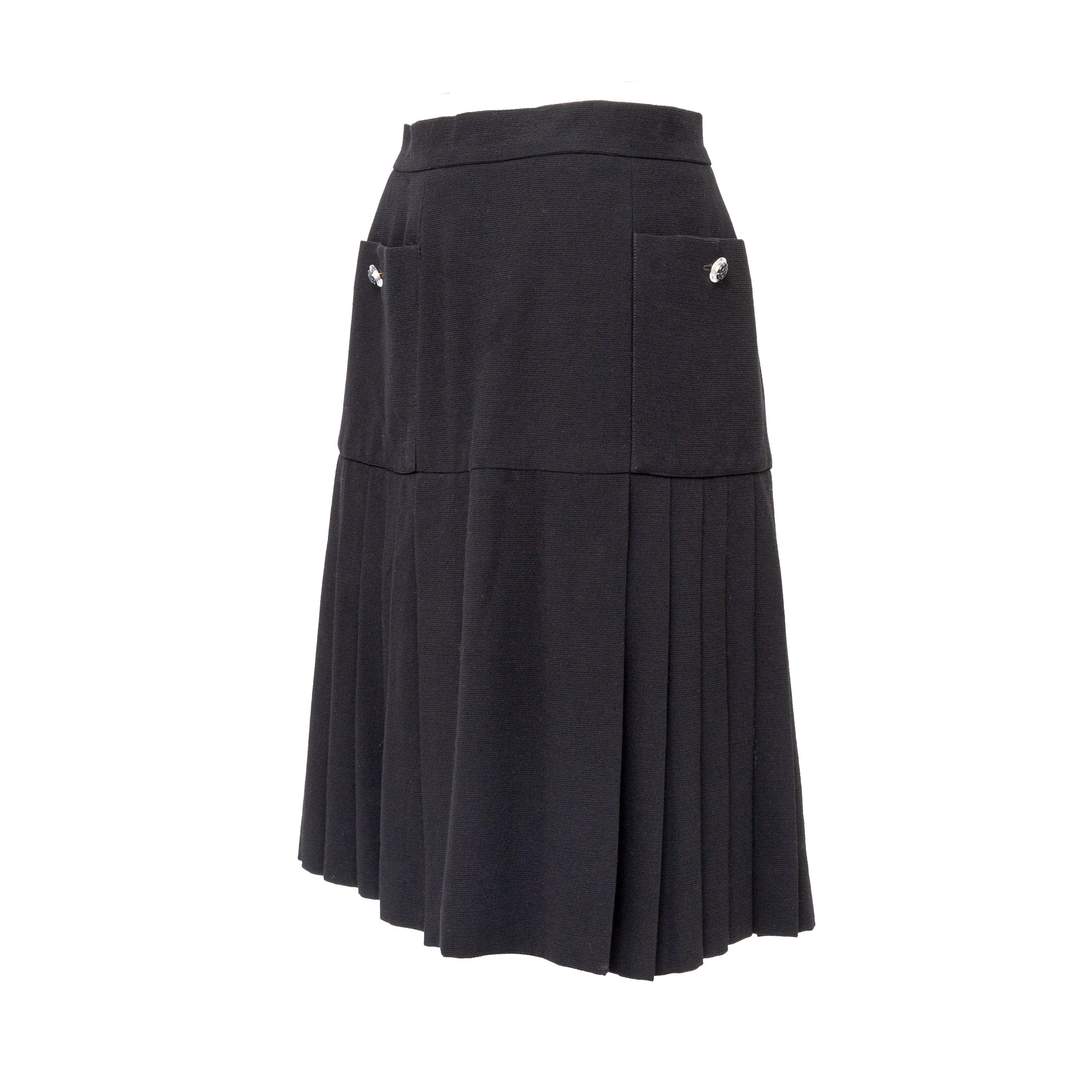 Elevate your wardrobe with this timeless Chanel Boutique Pleated Skirt from the Fall 2005 Collection by Karl Lagerfeld. Made of black wool with a flattering flared cut, it features double front pockets and pleated hemline detailing. The signature