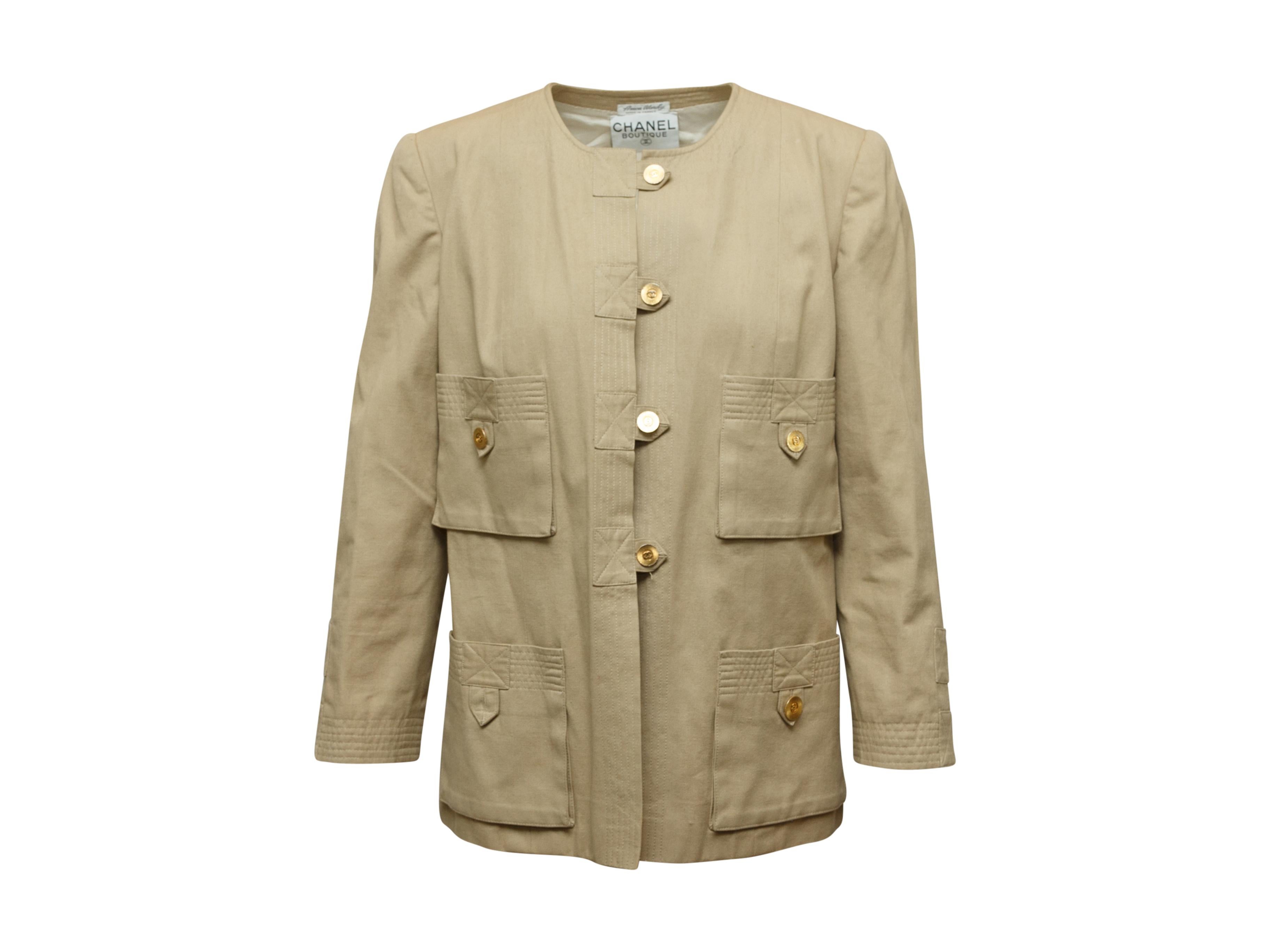 Product details: Vintage tan canvas jacket by Chanel Boutique. Crew neck. Four pockets. Gold-tone CC button closures at front. 38