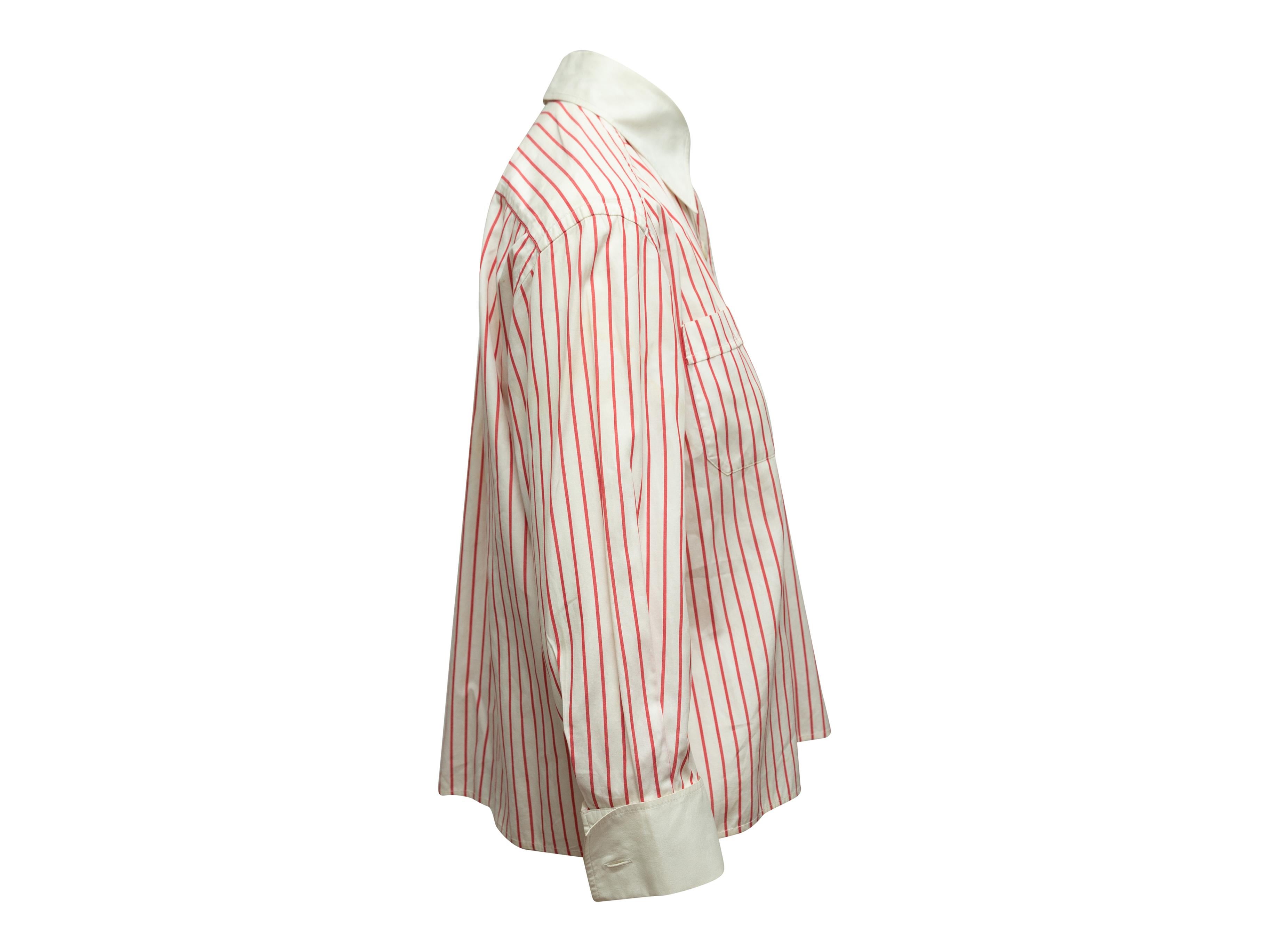Product details: Vintage white and red striped button-up top by Chanel Boutique. Pointed collar. Long sleeves. Button closures at center front. 38