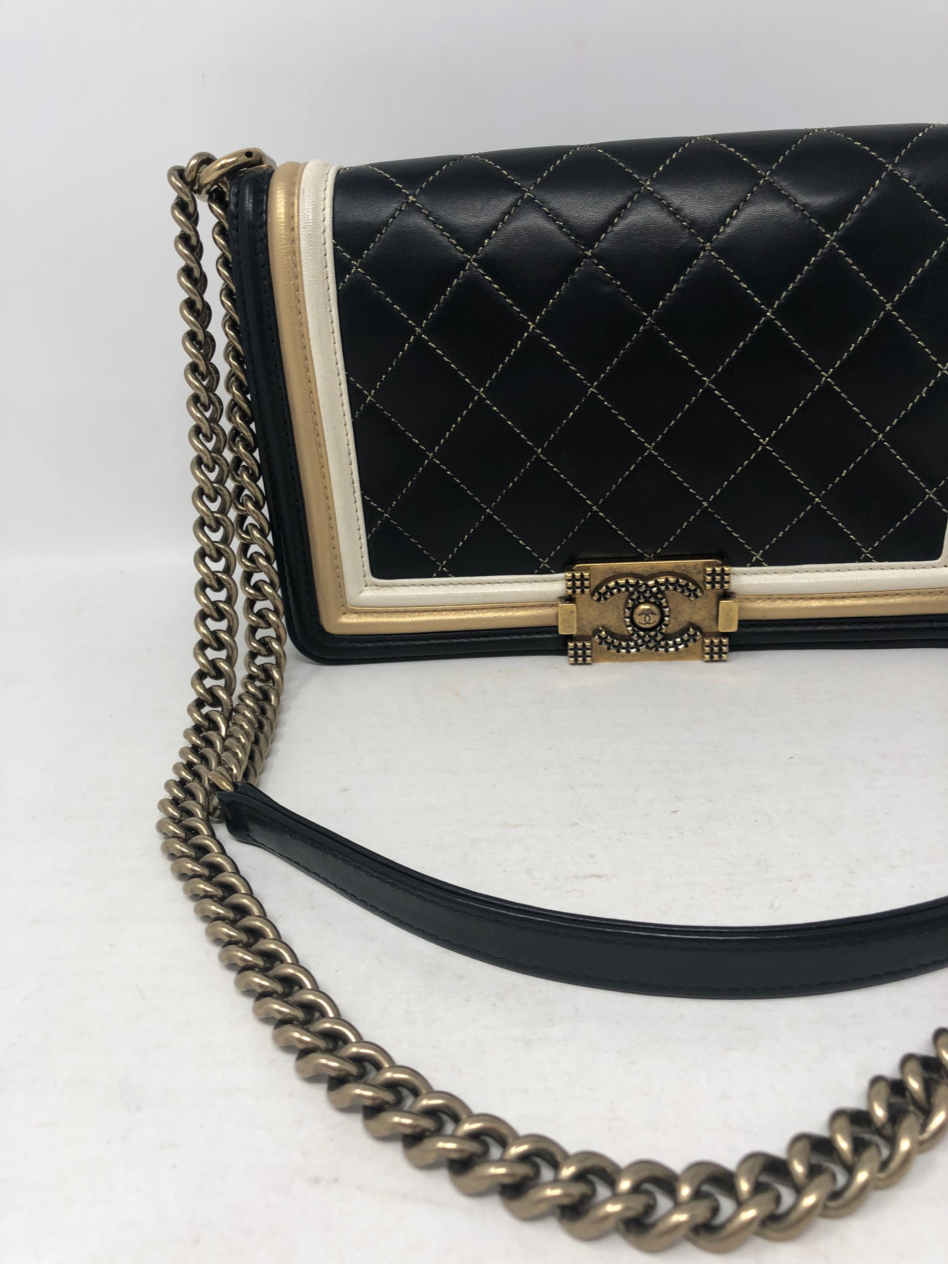 Rare Black Chanel Boy Bag with cream and gold trim. Limited gold hardware. Limited Cruise Collection 2012-2013. Mint condition. Includes authenticity card and dust cover. Guaranteed authentic. 